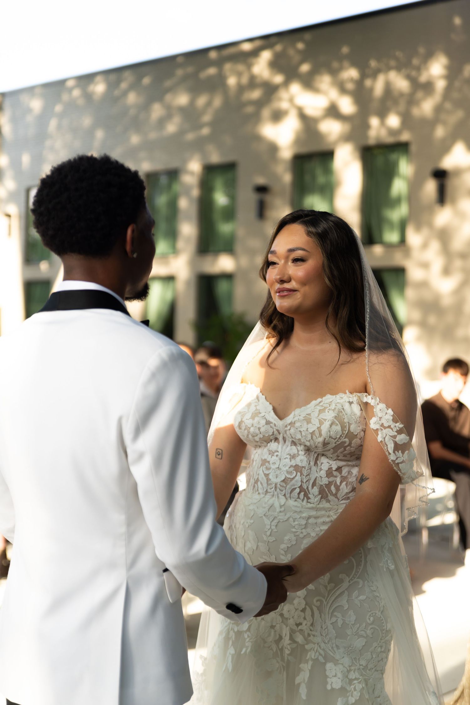 Bride and groom exchanging vows during outdoor wedding captured by Kin & Lens Creative Media wedding photographer in Dallas Fort Worth