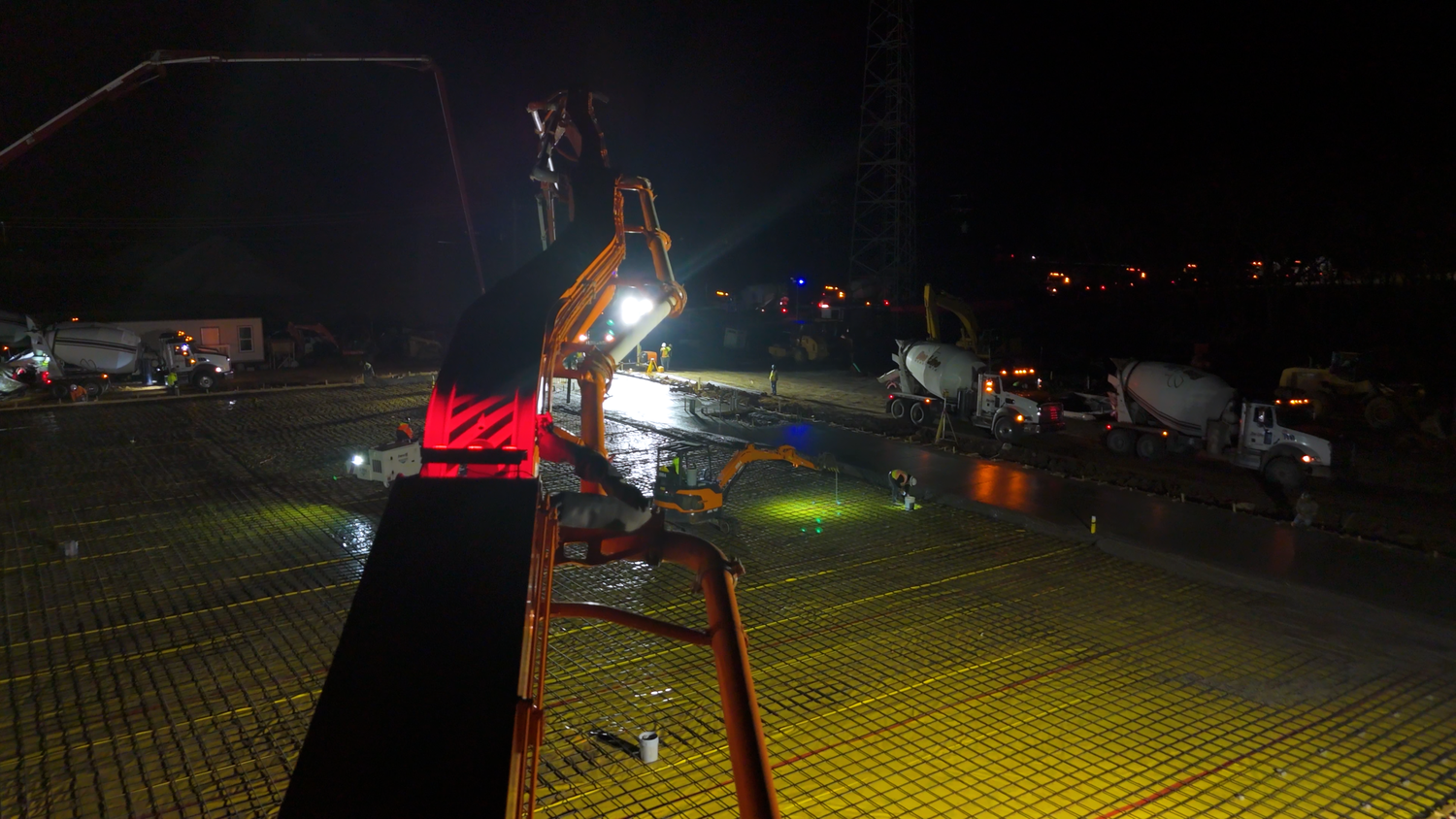 Heavy equipment operating on nighttime concrete project captured by Kin & Lens Creative Media construction photographer in Dallas Fort Worth