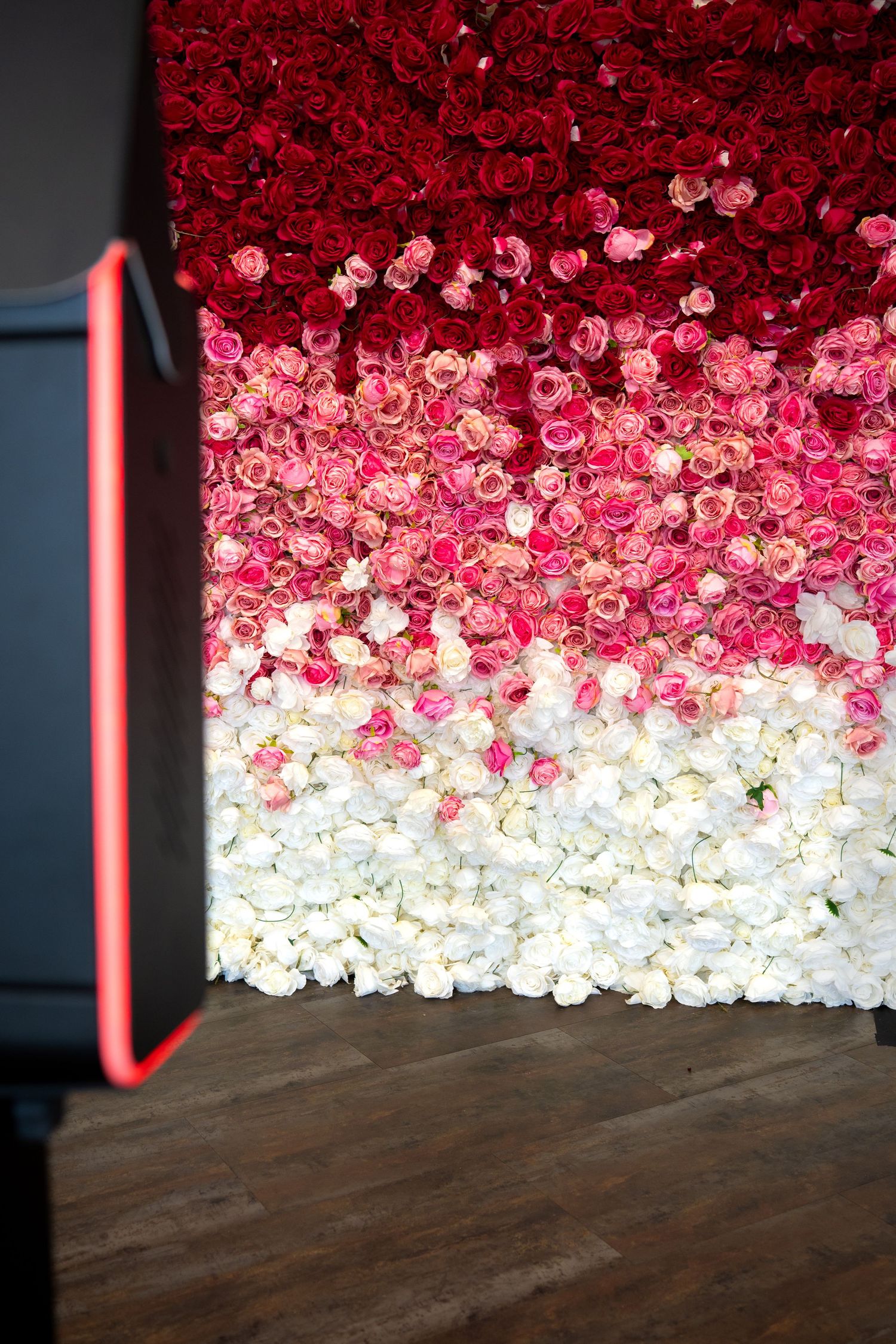 Premium DSLR photo booth setup with rose wall backdrop by Kin & Lens Creative Media, photo booth rental Dallas Fort Worth