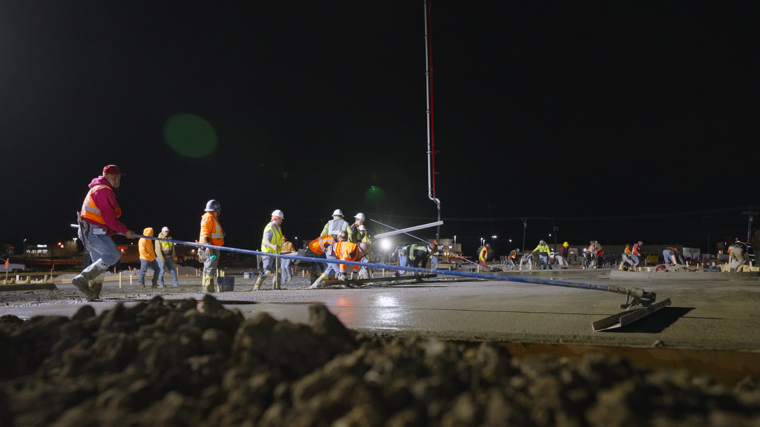 Concrete crew finishing large slab at night captured by Kin & Lens Creative Media industrial photographer in Dallas Fort Worth