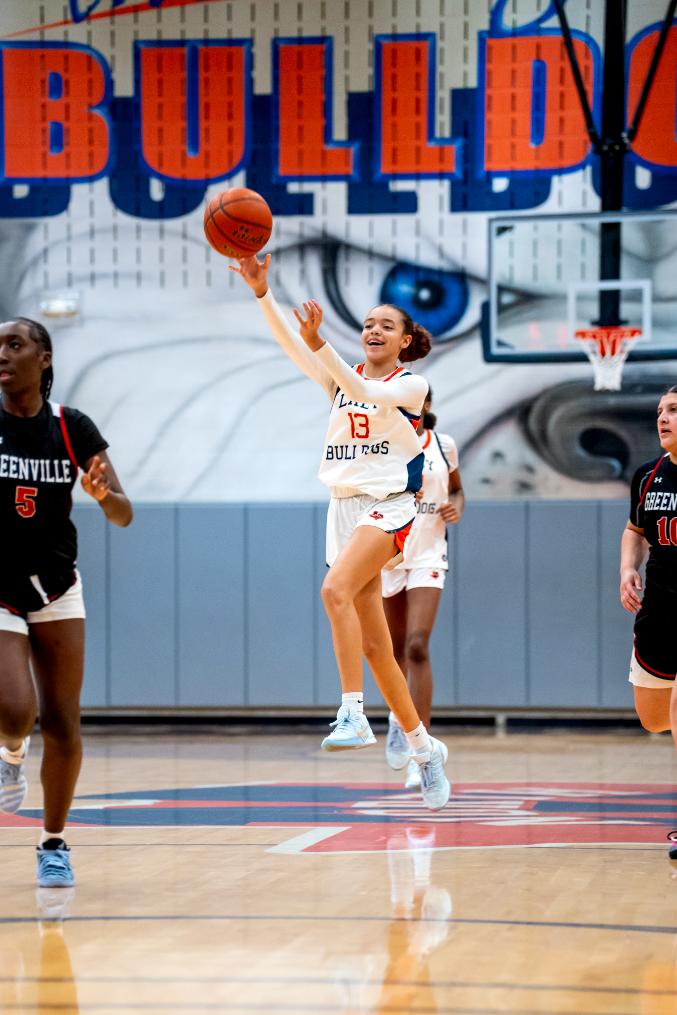 Basketball player shooting jump shot during high school game captured by Kin & Lens Creative Media sports photographer in McKinney Texas