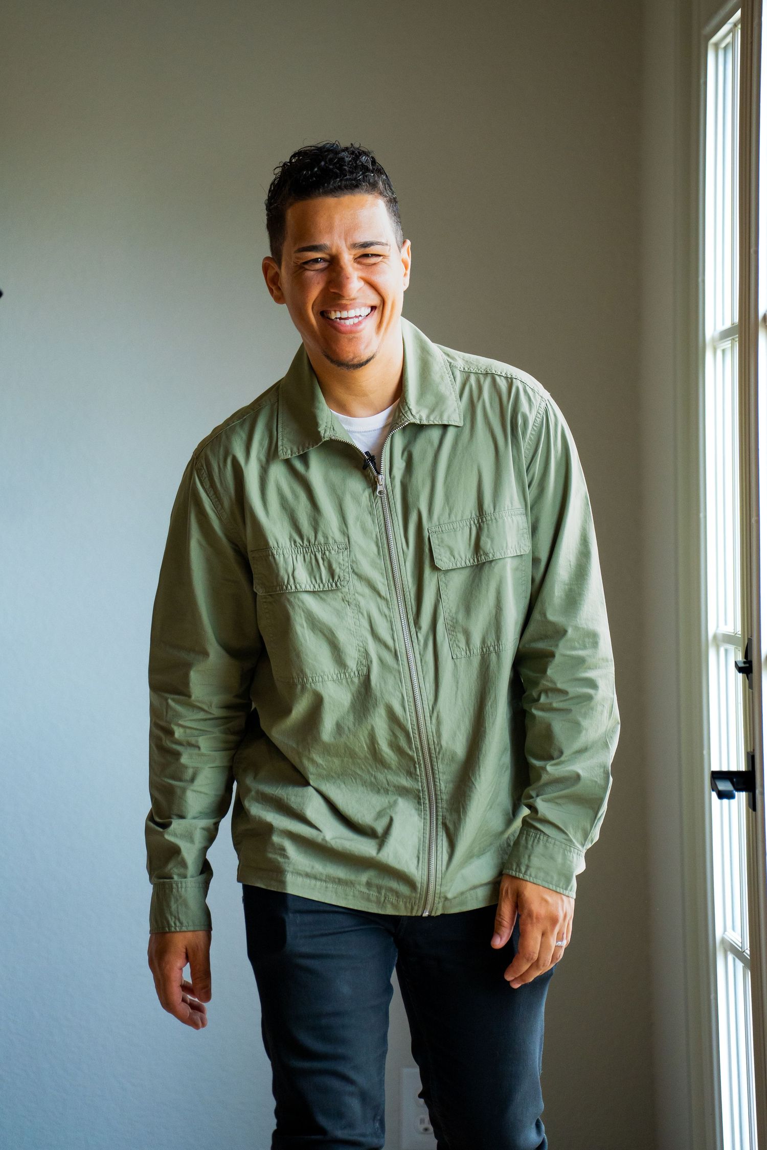 Lifestyle portrait of man by doorway captured by Kin & Lens Creative Media portrait photographer in Celina Texas