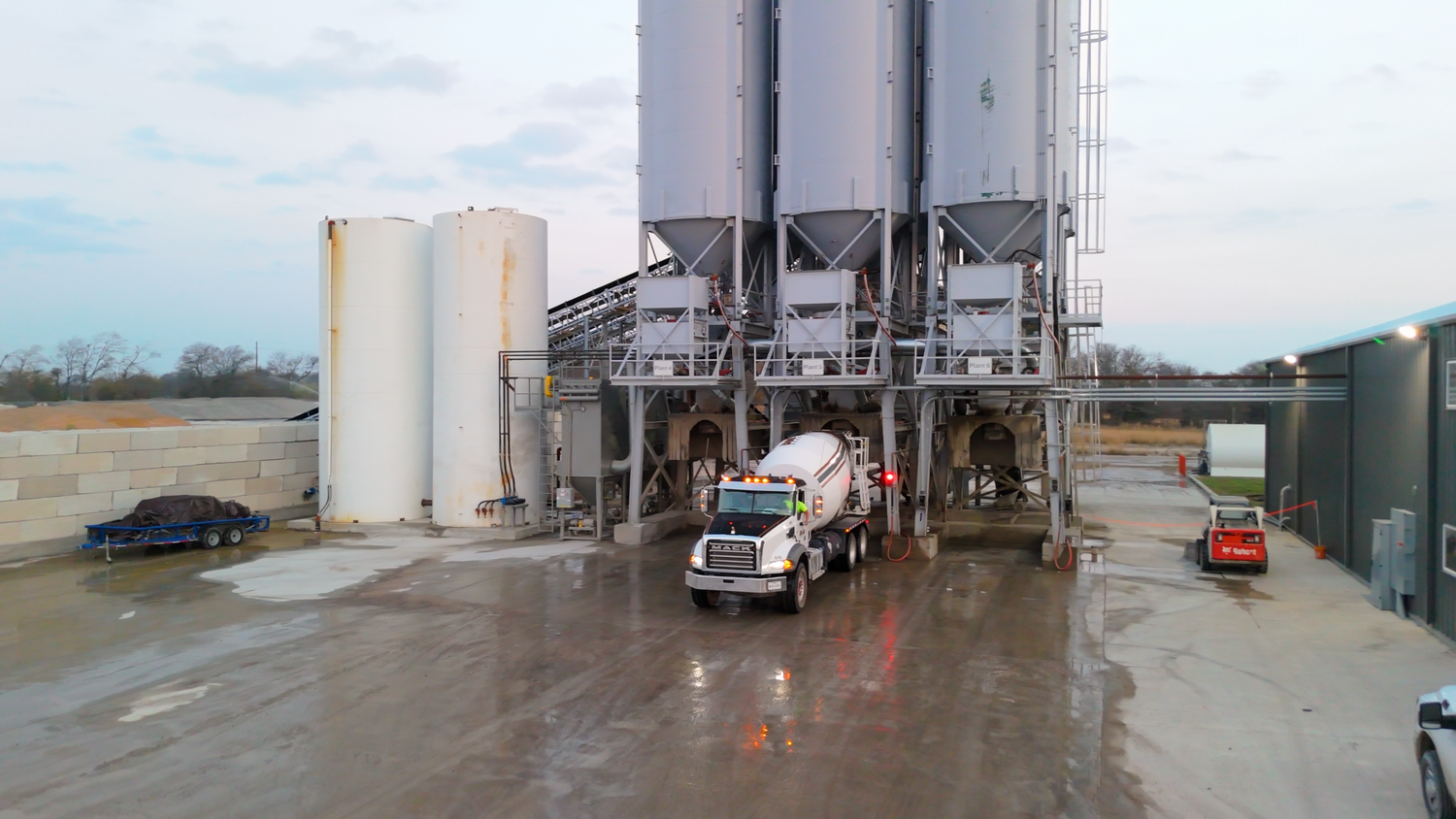 Concrete mixer truck at batching plant captured by Kin & Lens Creative Media construction photographer in Dallas Fort Worth