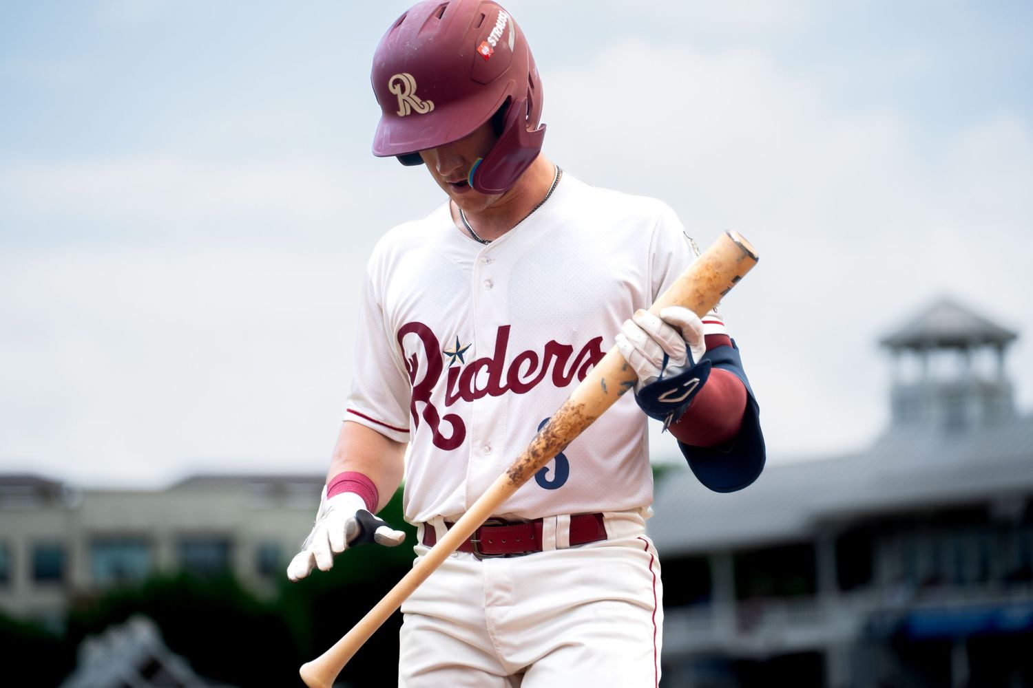 Frisco Roughriders baseball player in uniform practicing batting stance on field in Frisco, TX by Kin & Lens Creative Media