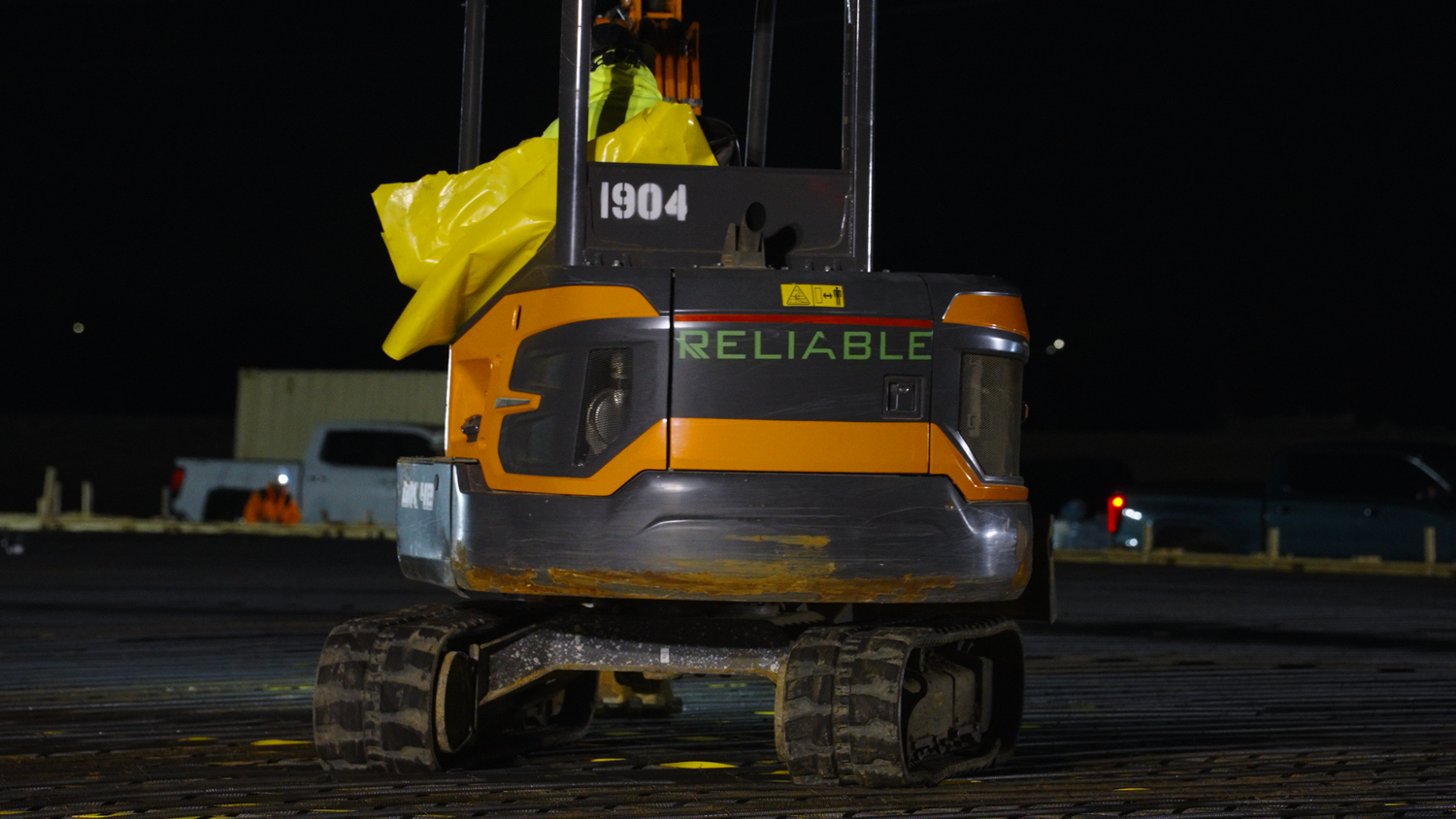 Compact excavator on nighttime construction site captured by Kin & Lens Creative Media construction photographer in Dallas Fort Worth