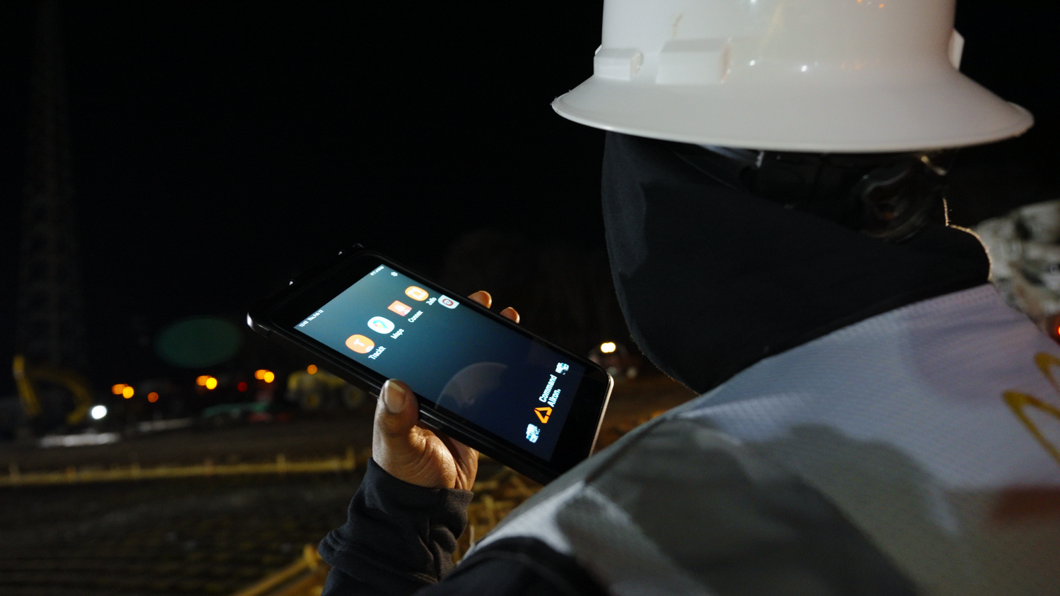 Construction worker checking job site plans on tablet captured by Kin & Lens Creative Media construction photographer in Dallas Fort Worth