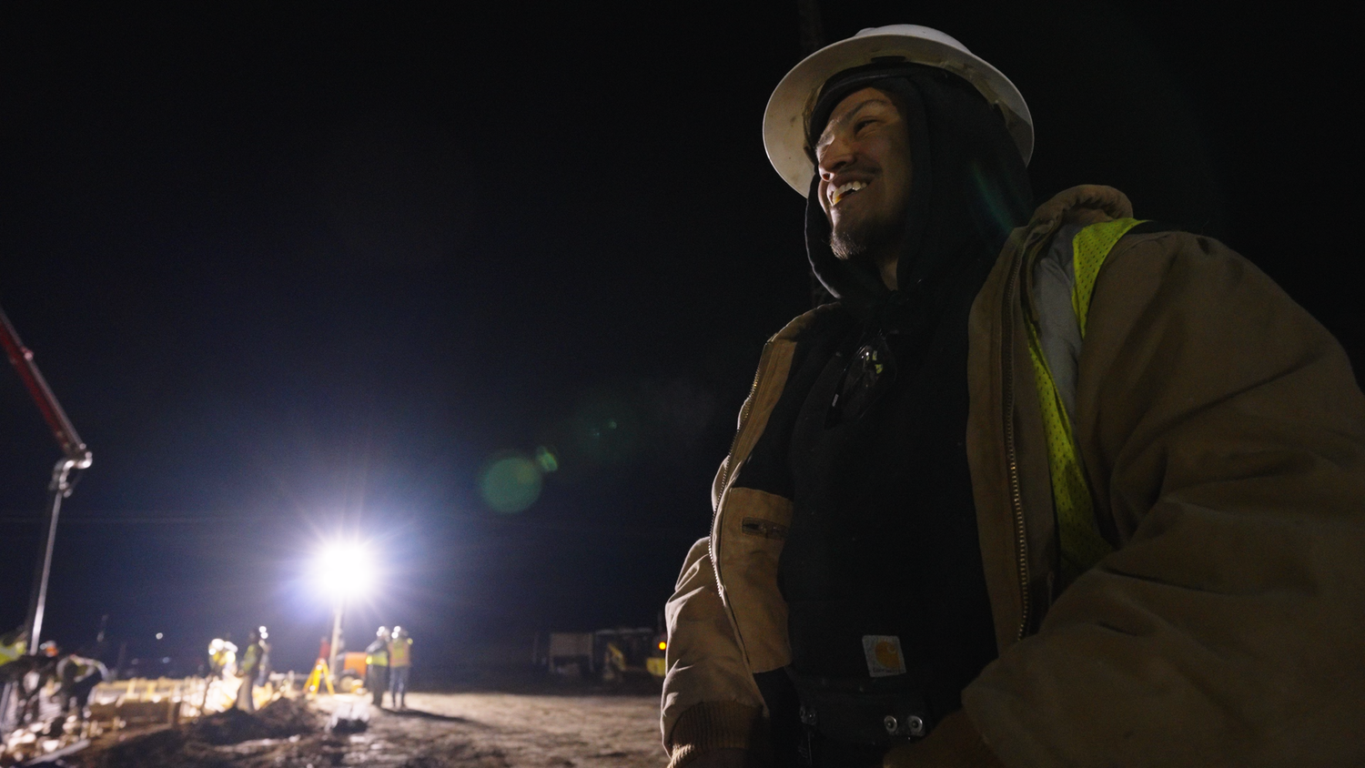 Construction worker on nighttime job site captured by Kin & Lens Creative Media construction photographer in Dallas Fort Worth