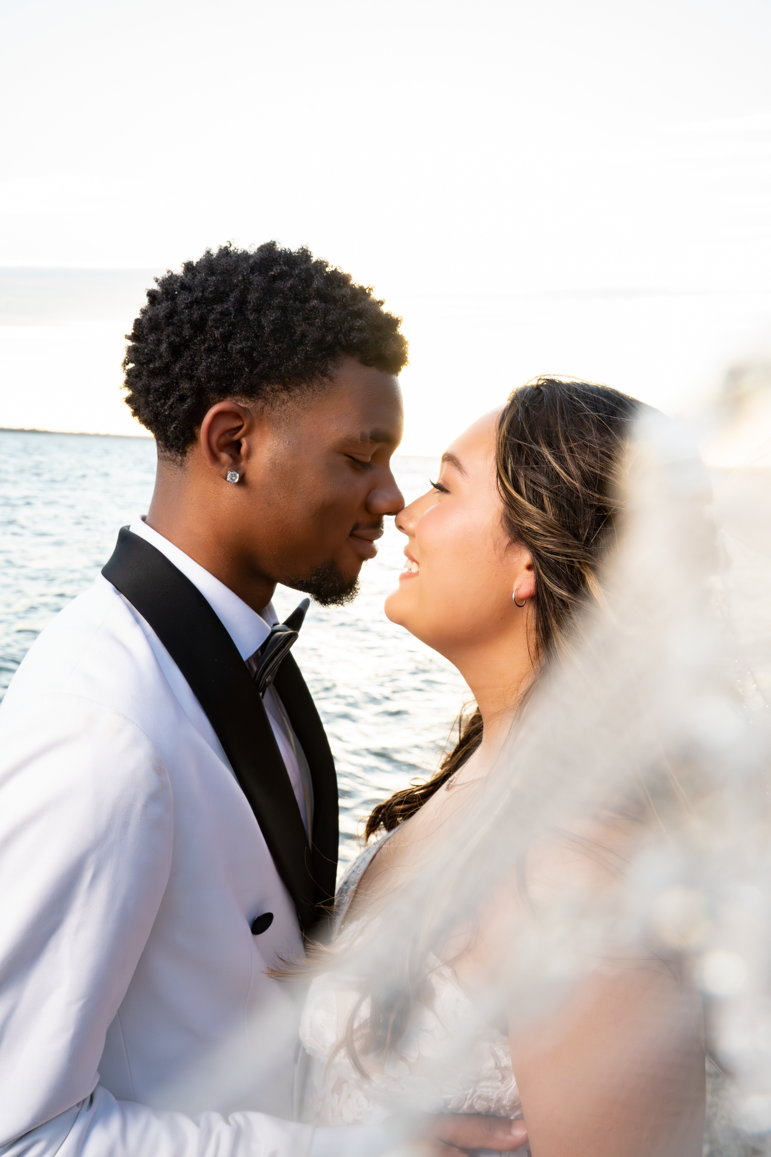 Romantic wedding couple shares intimate moments by the water in Grapevine, TX by Kin & Lens Creative Media