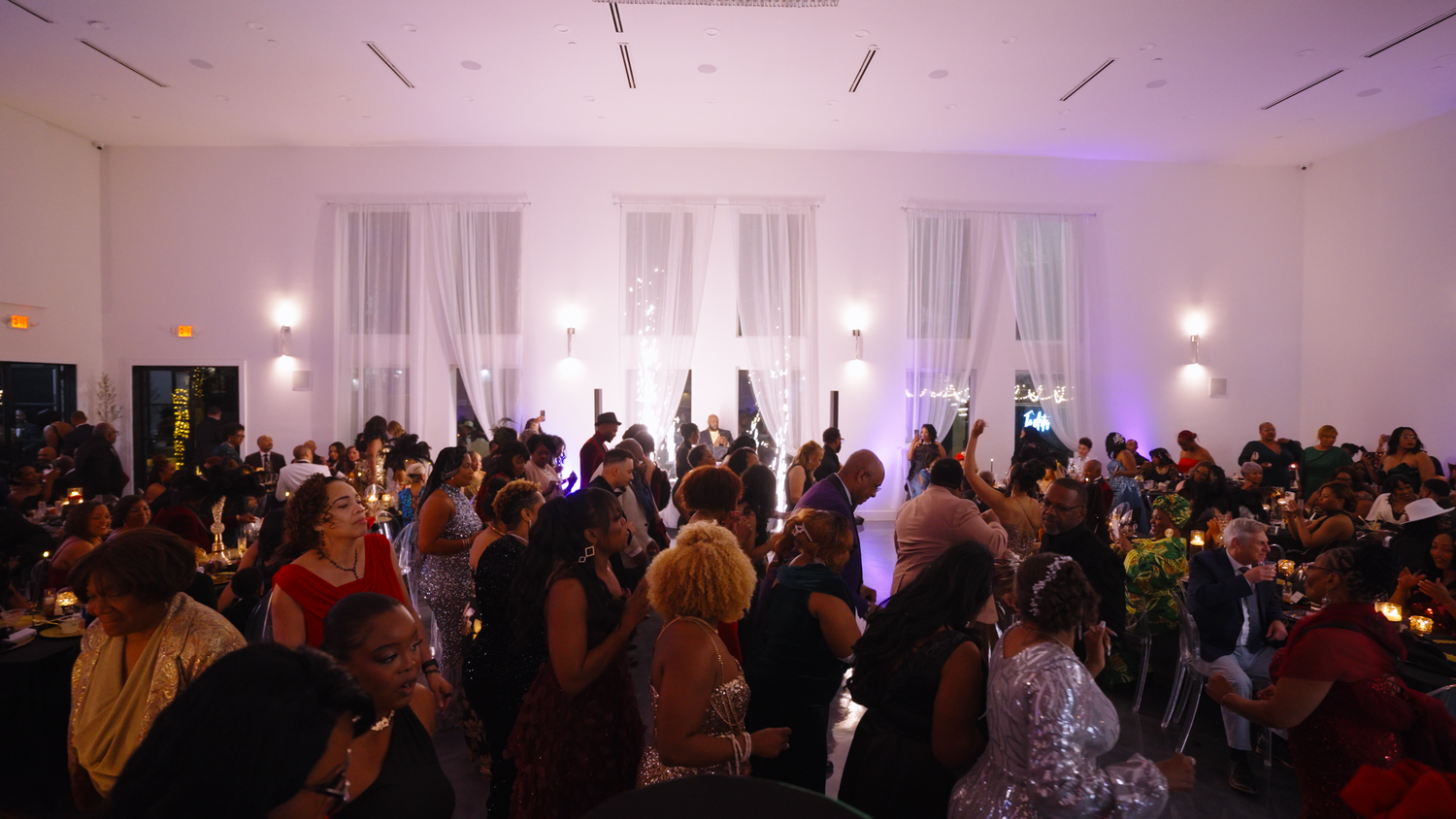 Crowd enjoying formal gala celebration photographed by Kin & Lens Creative Media event photographer in Dallas Fort Worth