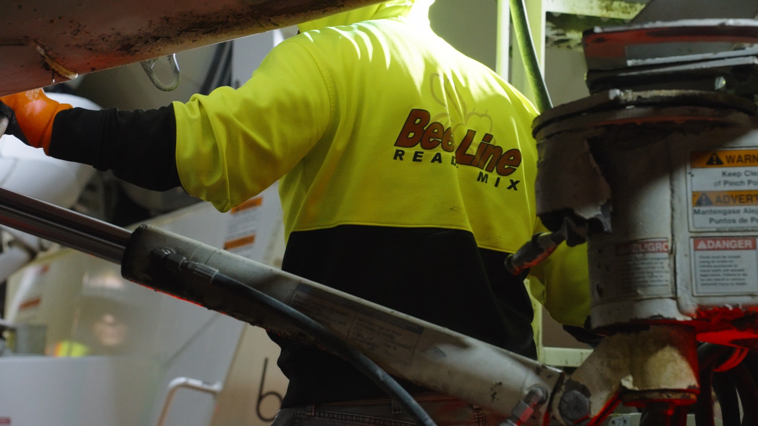 Concrete worker operating equipment on job site captured by Kin & Lens Creative Media construction photographer in Dallas Fort Worth