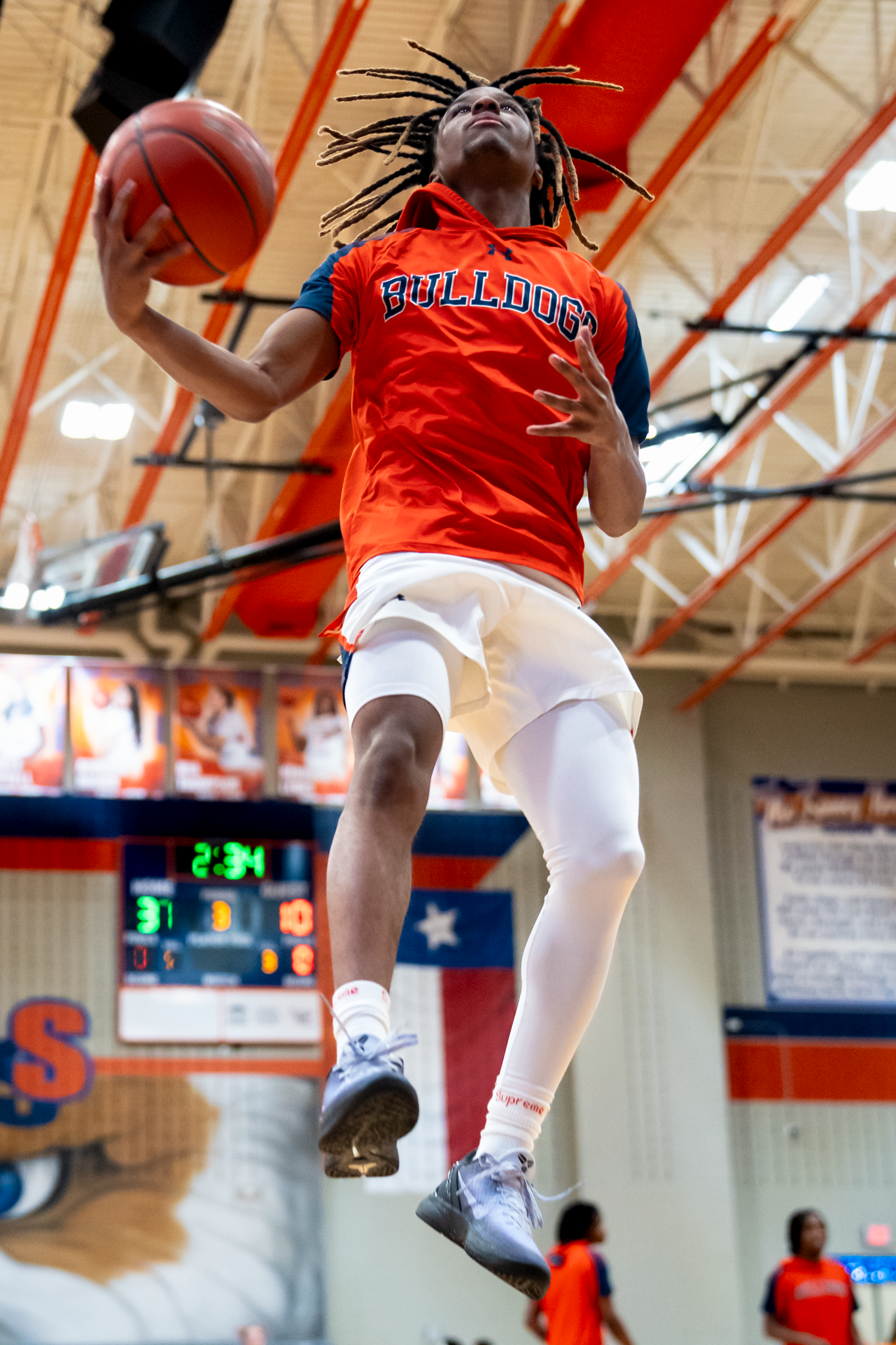 High school basketball player dunking during game captured by Kin & Lens Creative Media sports photographer in McKinney Texas
