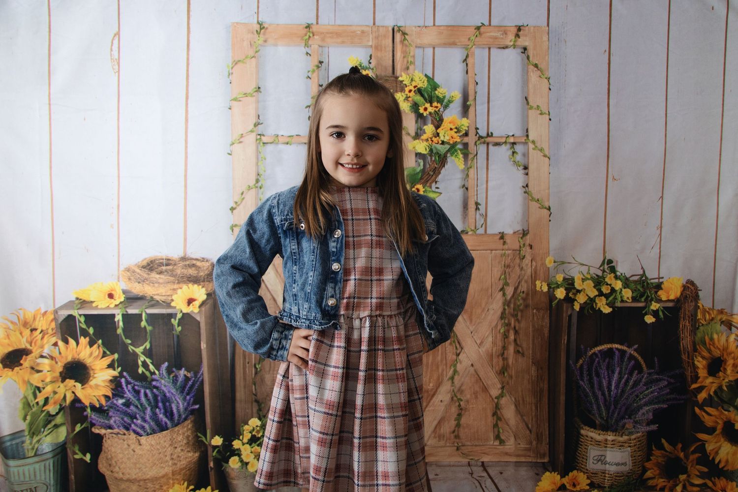 Rustic fall decor with sunflowers against a white wooden wall backdrop.