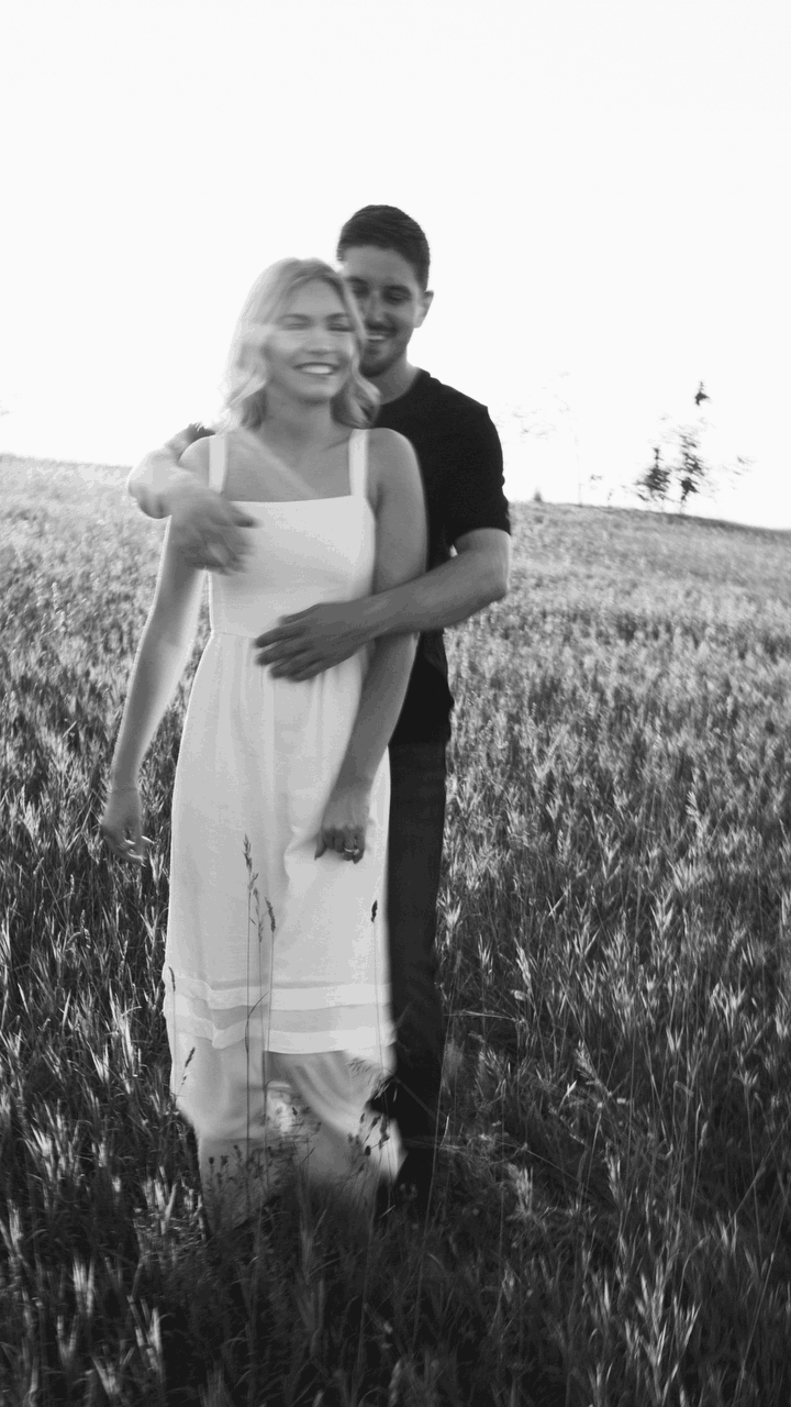 Couple smiling during a photoshoot. Pinterest inspo couples shoot. Engagement shoot