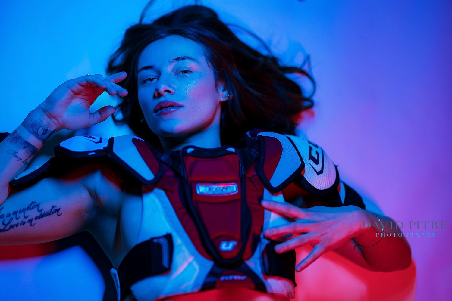 Fashion photography series with vibrant neon lighting effects in red and blue tones creating a cinematic mood.