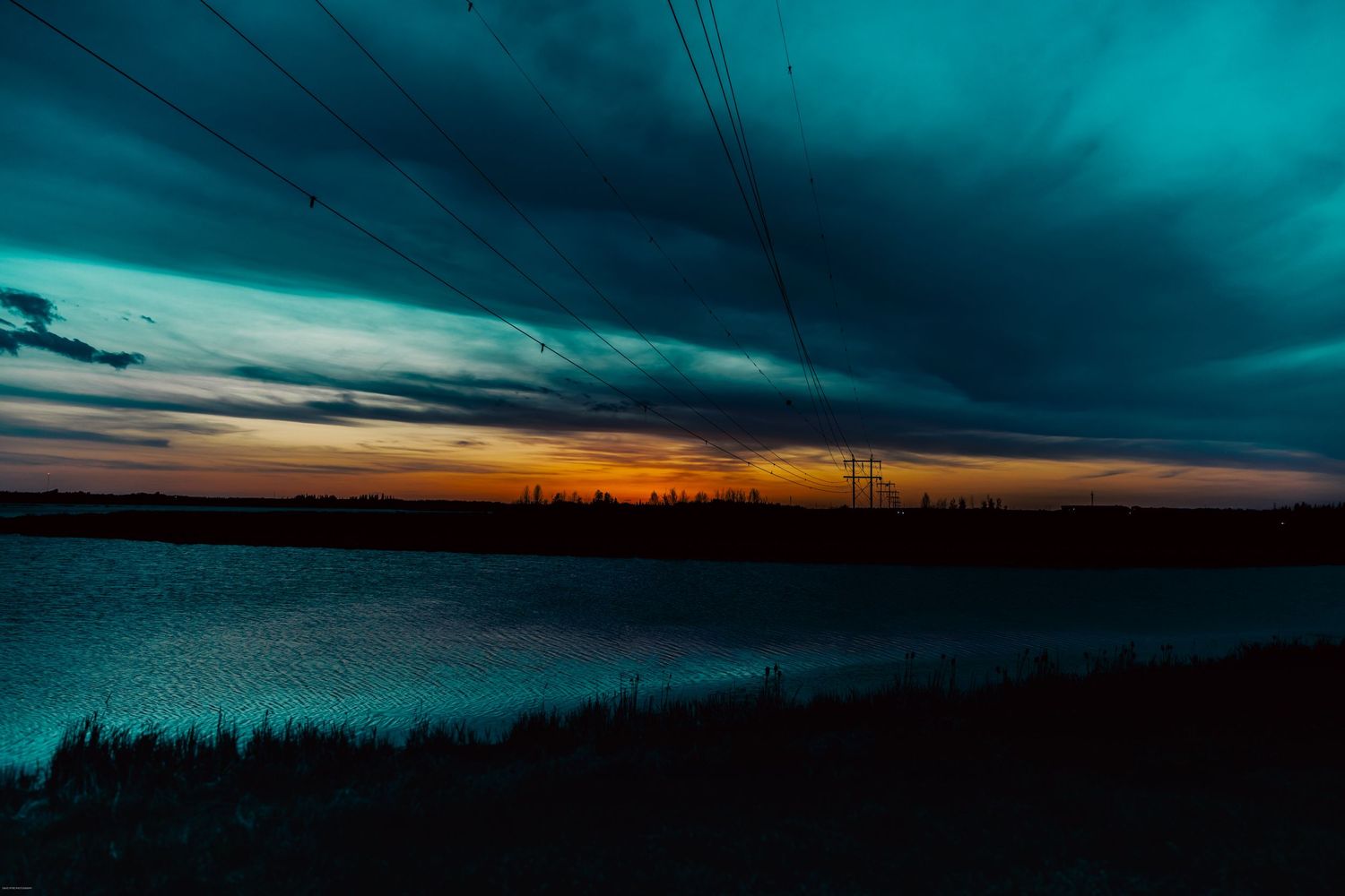 A series of tranquil sunset photos showing dramatic skies with vibrant orange and teal colors over silhouetted landscapes.
