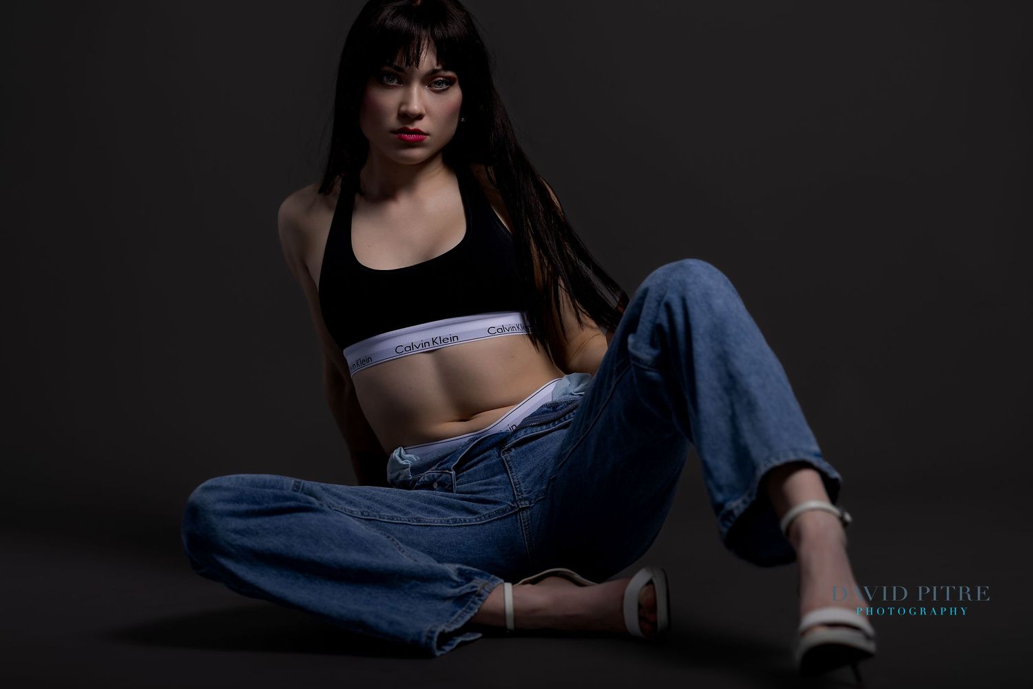 Artistic black and white portrait series showing a person in denim against dark backgrounds.