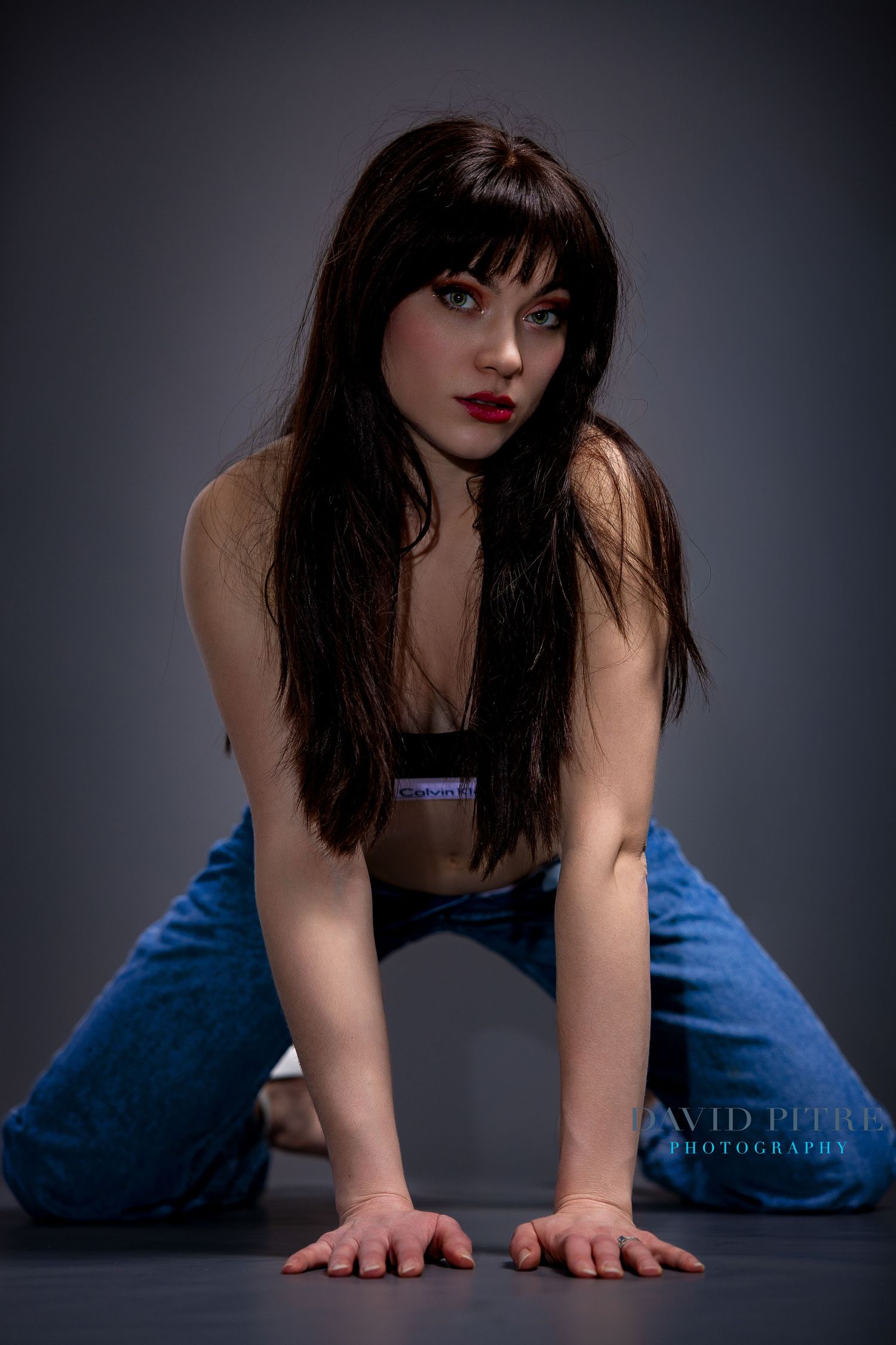 Dramatic black and white fashion photo series showing model in blue denim against dark background.