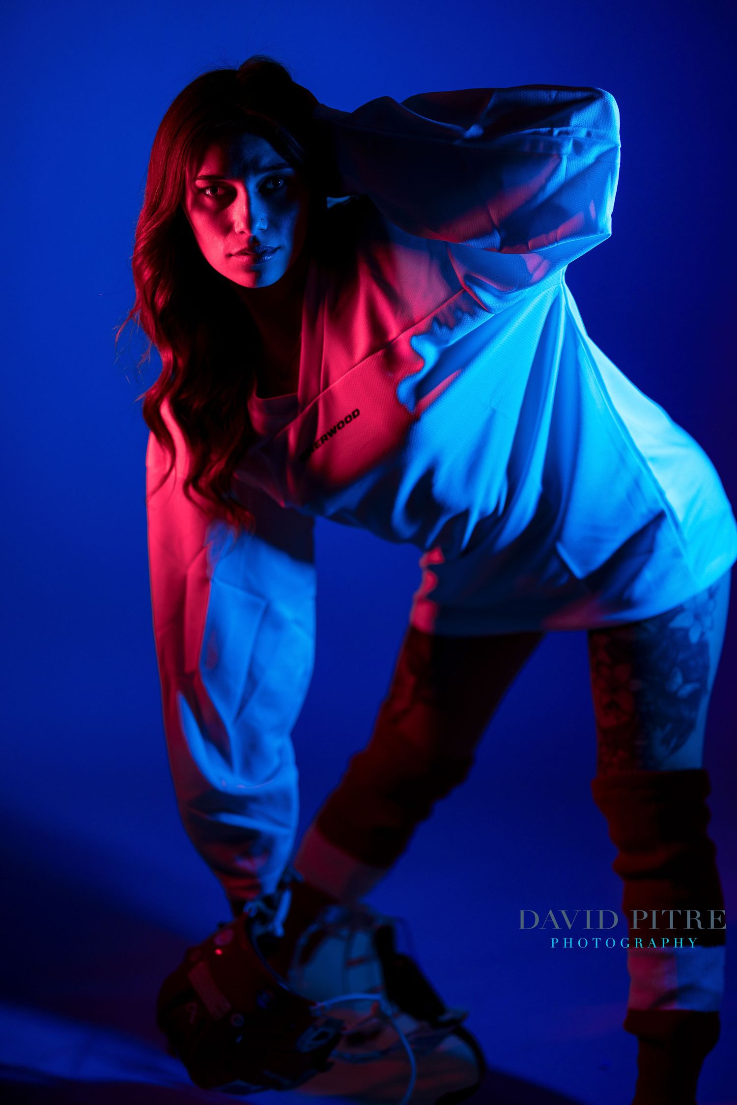 Dynamic low-angle shots with contrasting red and blue lighting creating dramatic shadows.