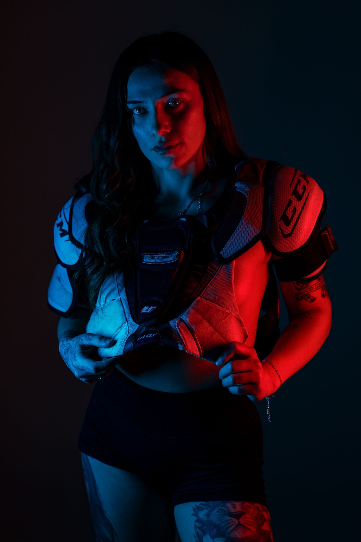 A series of dark moody portraits lit with dramatic red and blue lighting creating a cinematic effect.