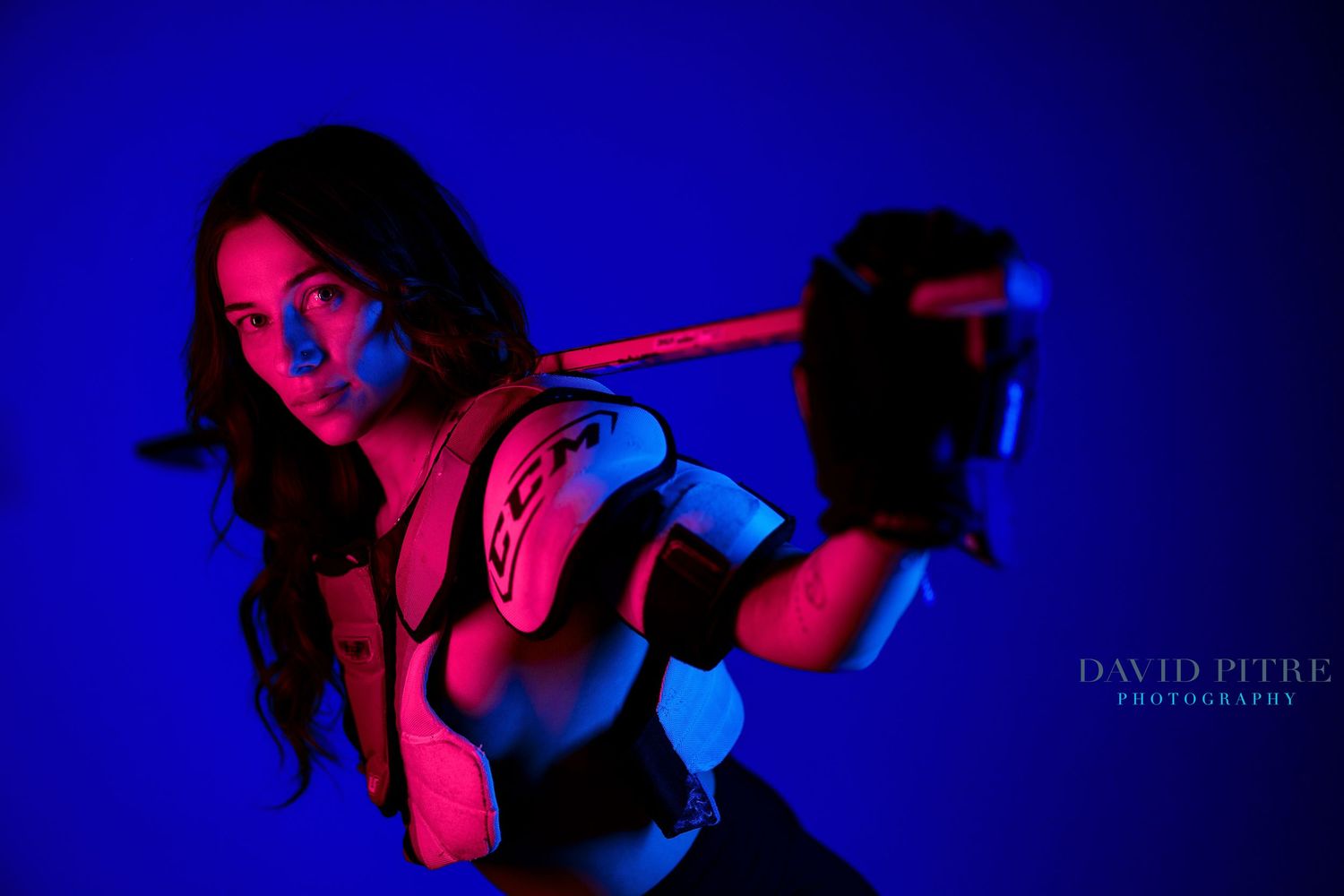 Artistic photo series with figure silhouetted against vibrant blue and red lighting effects.