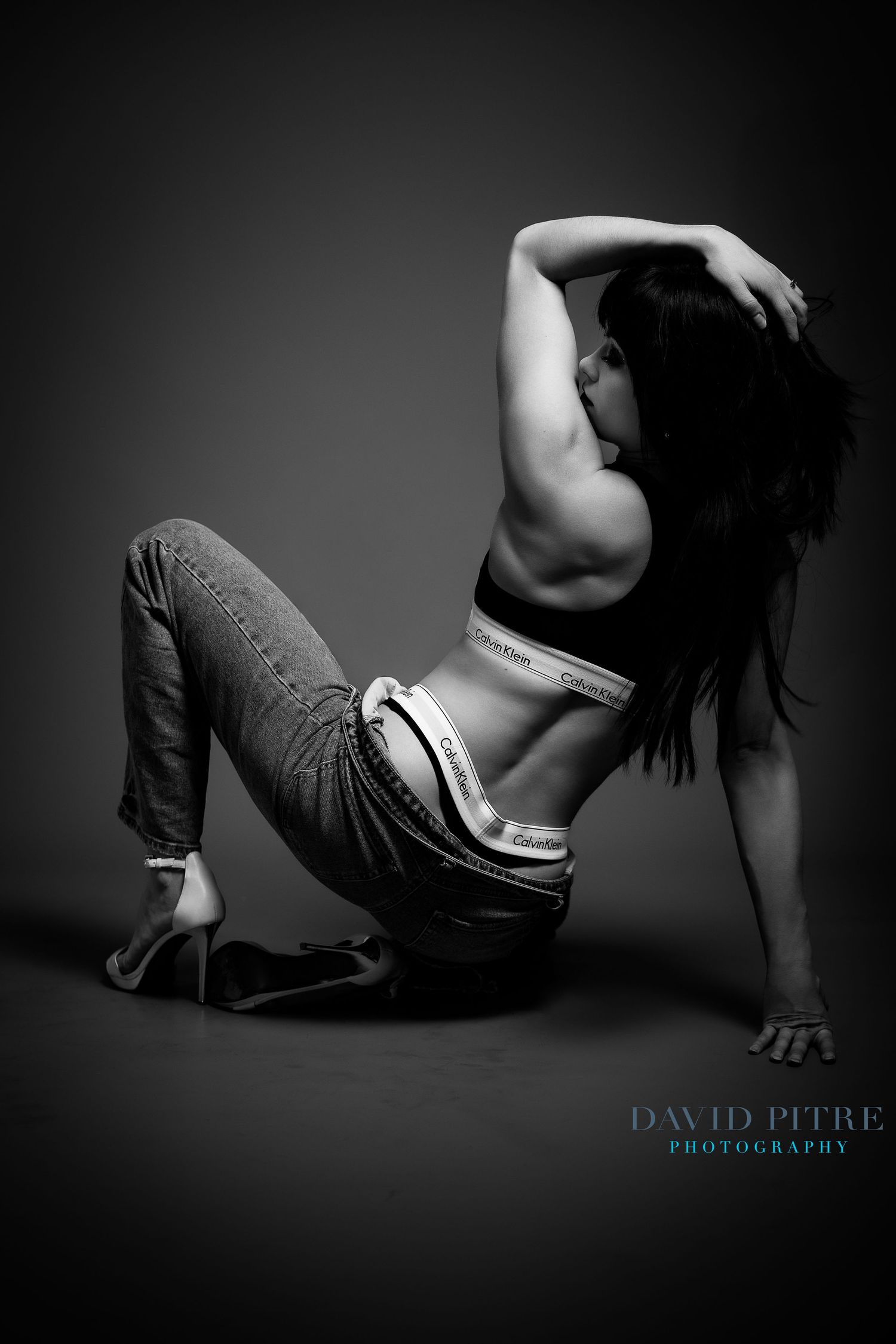 Artistic black and white boudoir photo sequence showing dramatic poses and shadows against dark background.