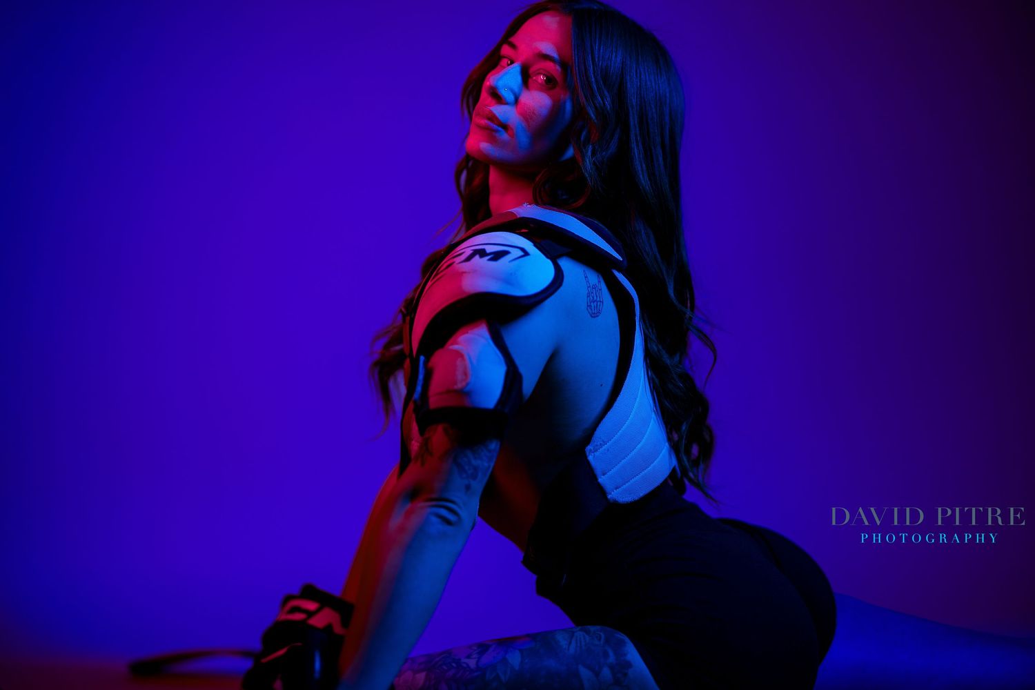 Moody portrait series with dramatic blue and red lighting against deep purple background.