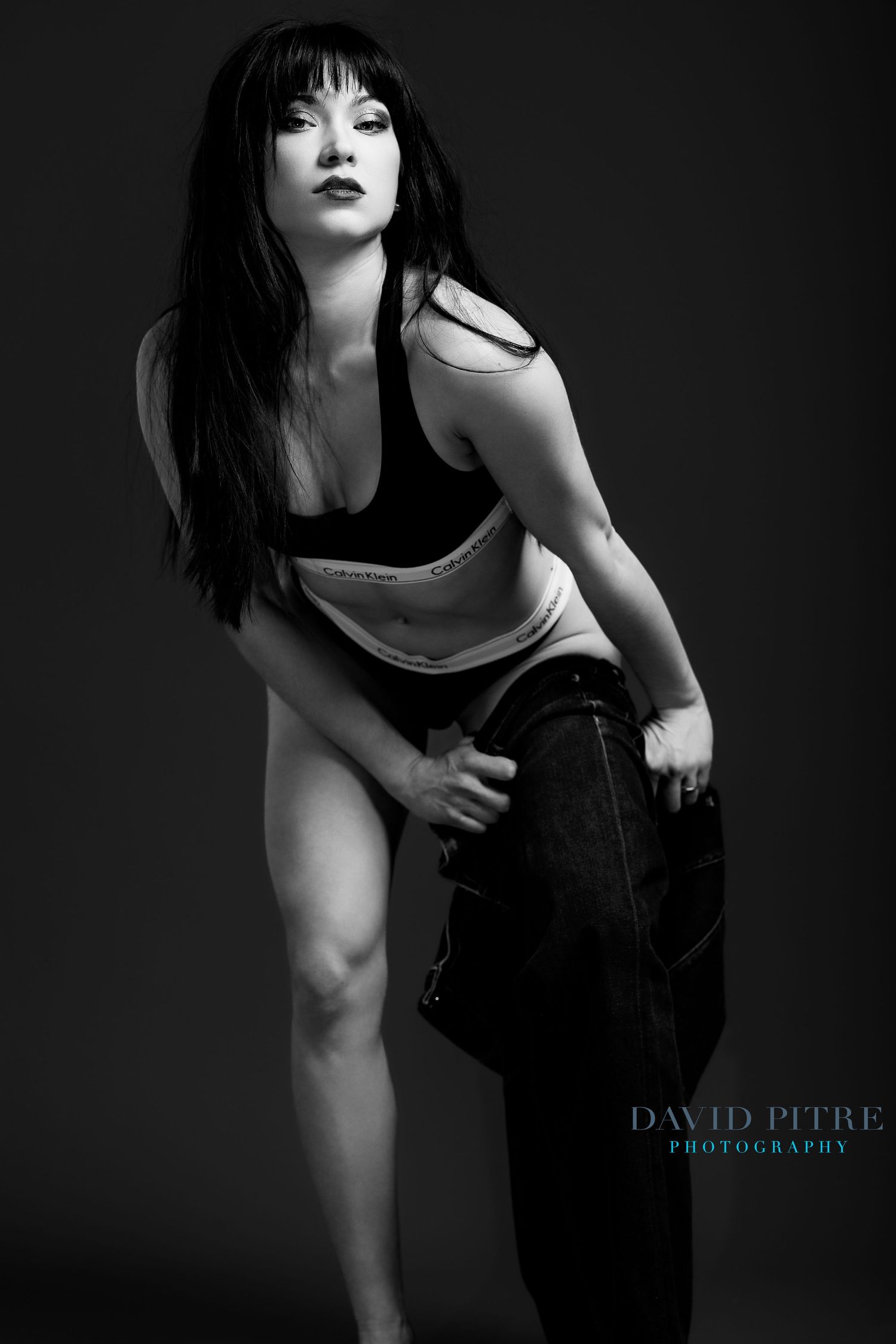 Dramatic black and white fashion portraits showing movement and poses in studio lighting.