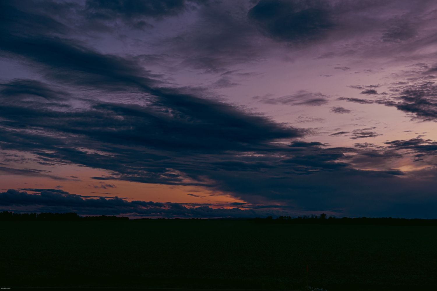 A series of panoramic landscape photos showing dramatic purple and dark cloudy skies at sunset or dusk.