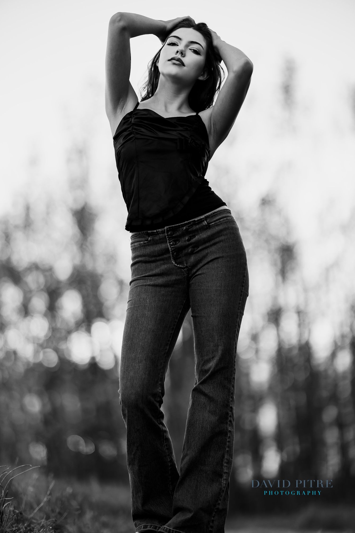 A black and white artistic portrait series showing a figure in dark clothing posing expressively against a blurred background.