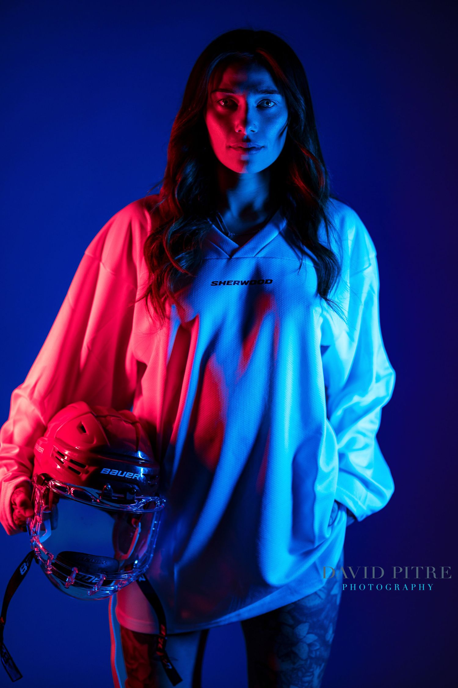 Stylized photography series featuring bold red and blue lighting on a figure in white clothing.