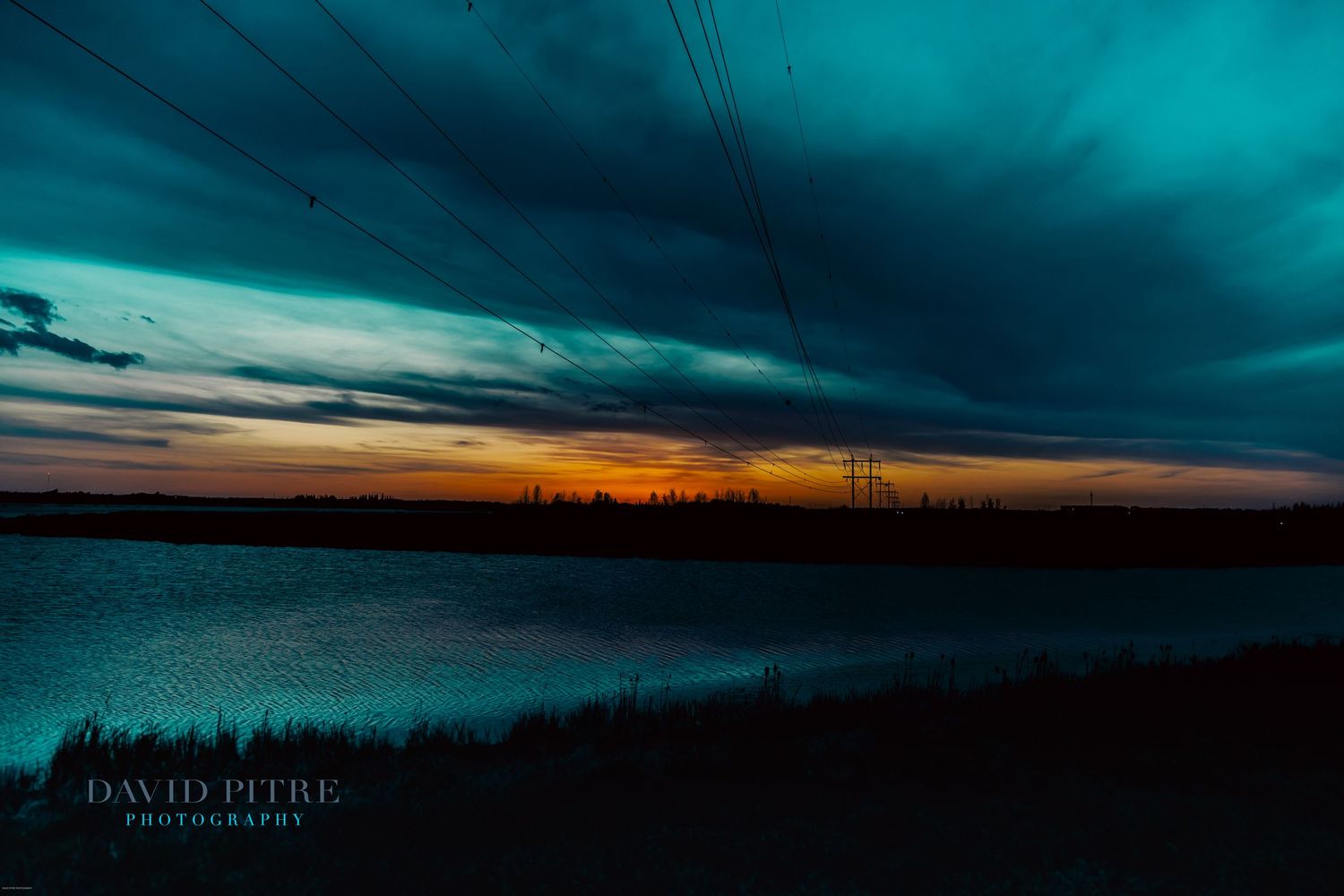 Panoramic series of dark turquoise and orange sunset skies over a silhouetted landscape at dusk.