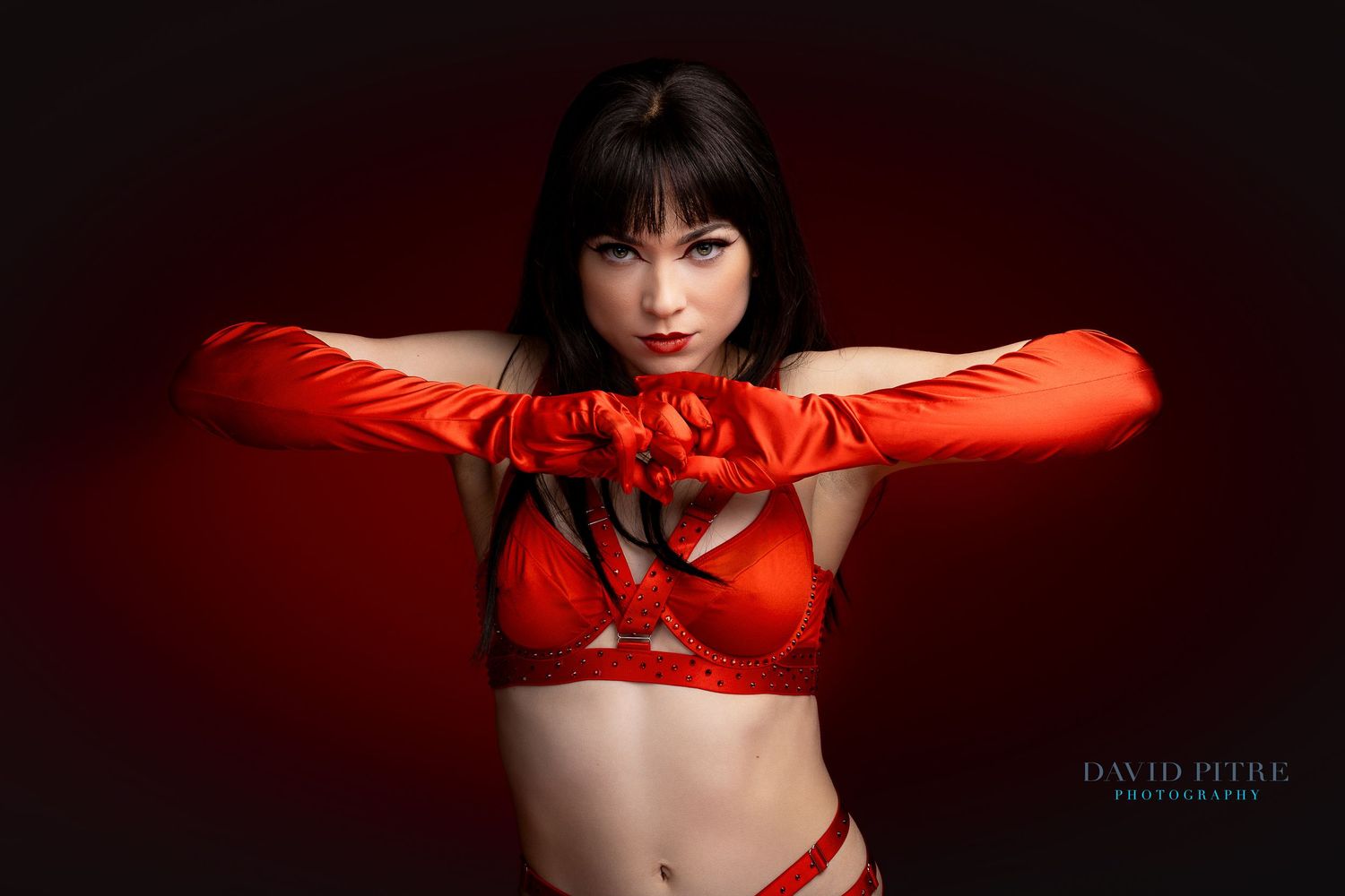 Artistic fashion photo series in red and black tones showing dramatic poses against dark background.