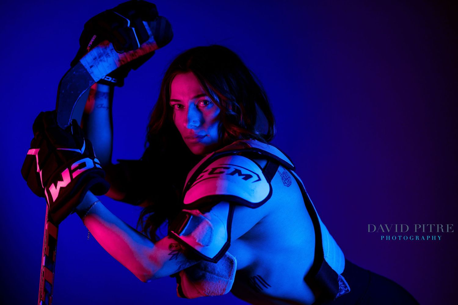 Dynamic fitness photography sequence with deep blue lighting and dramatic poses against dark background.