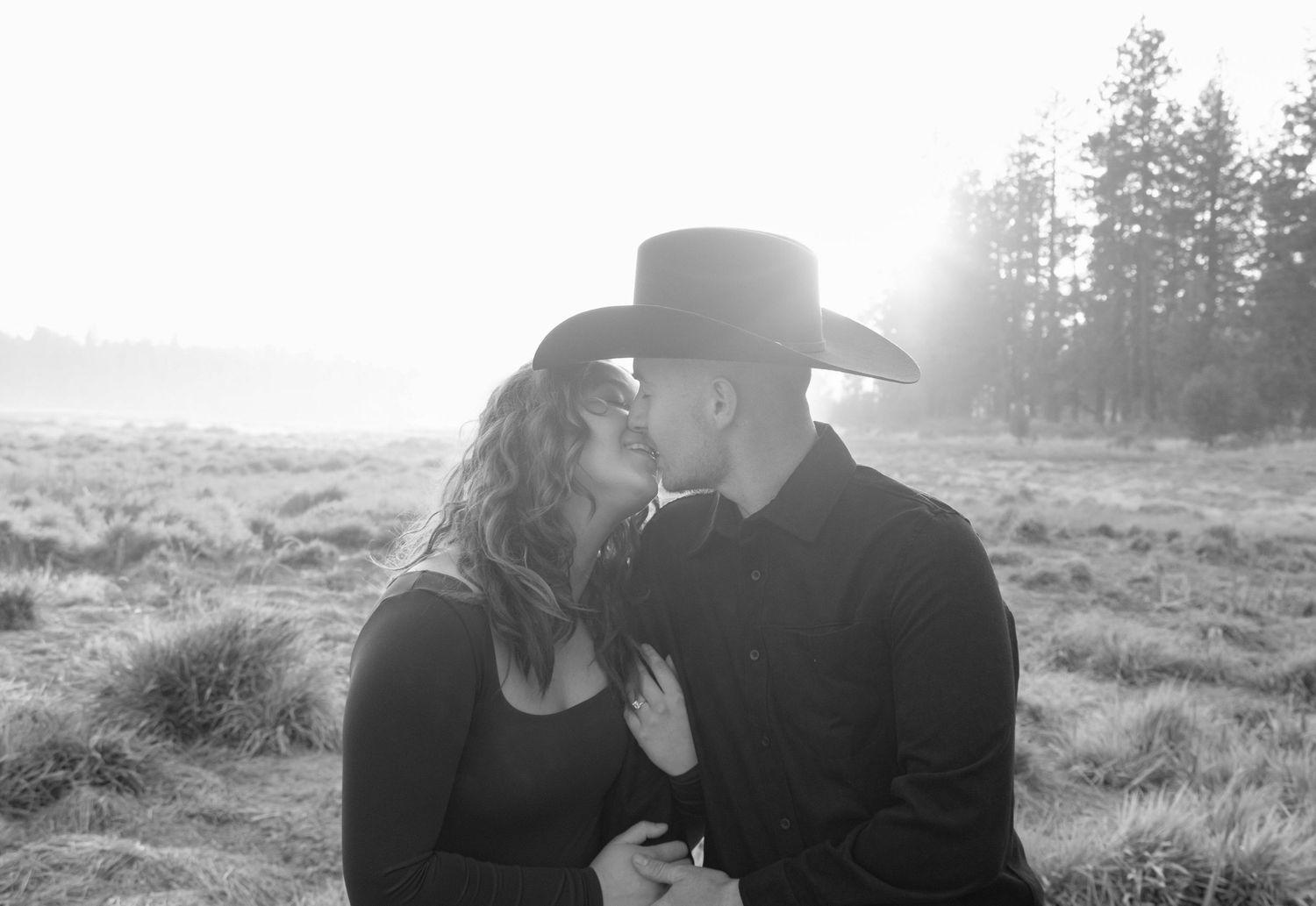 a couple kisses, lit up by the Oregon sun