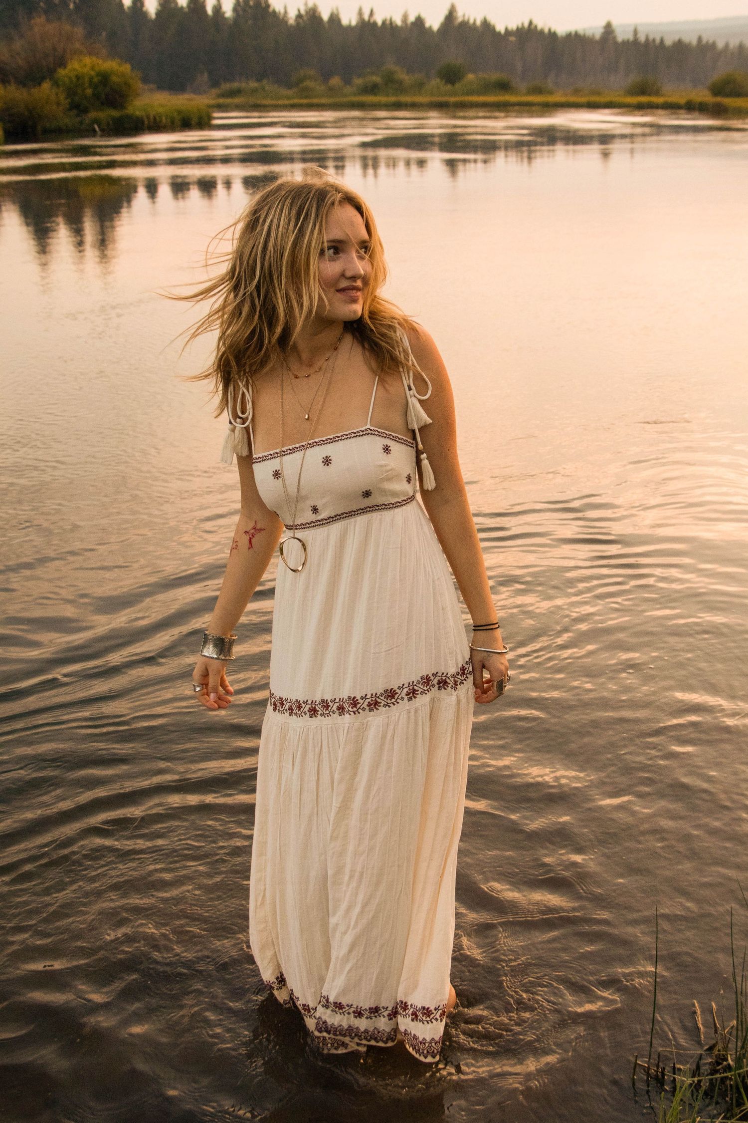 a young woman stands in a river at a park in Bend, Oregon