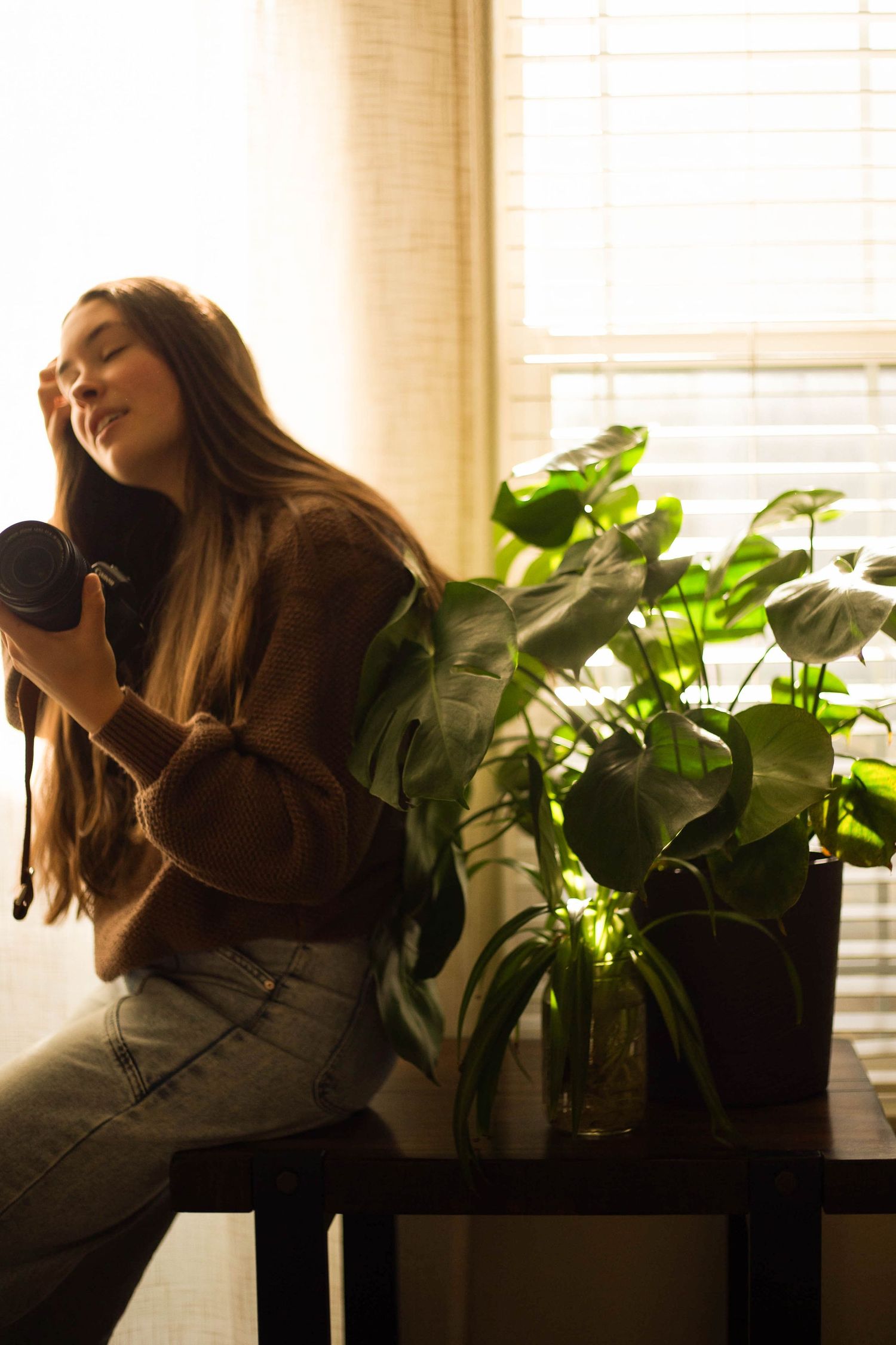 a photographer holds her camera at her studio in Bend, Oregon