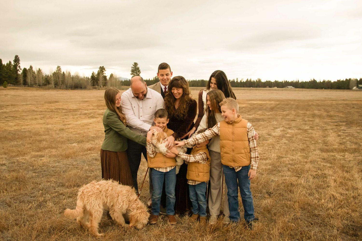 a family with seven children pet their dog at their property in Bend, Oregon