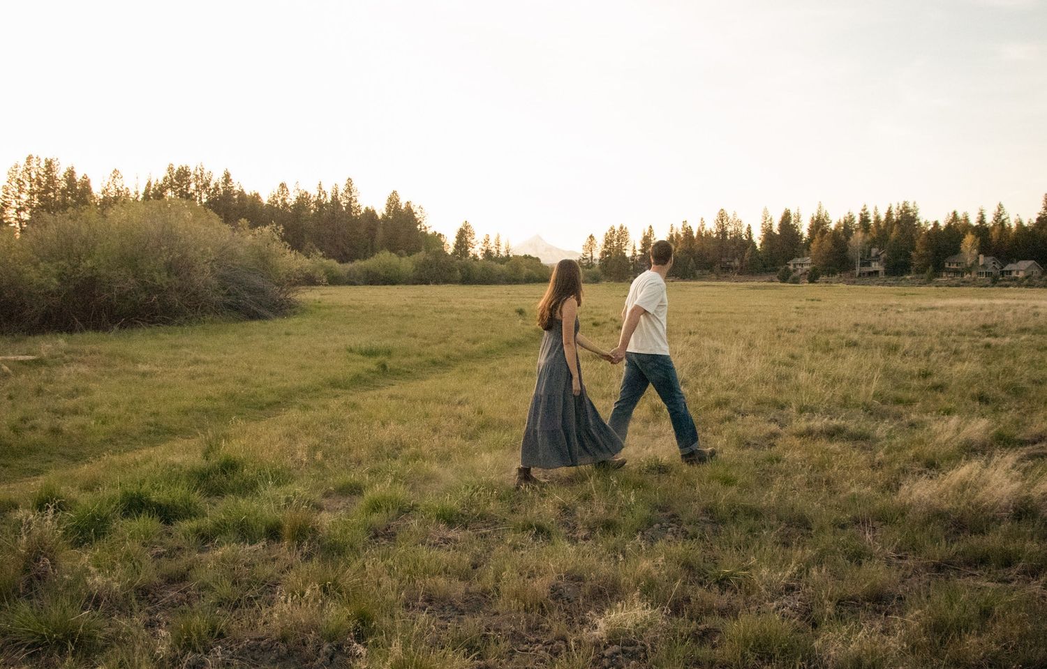a couple walks through a meadow in Sisters, Oregon