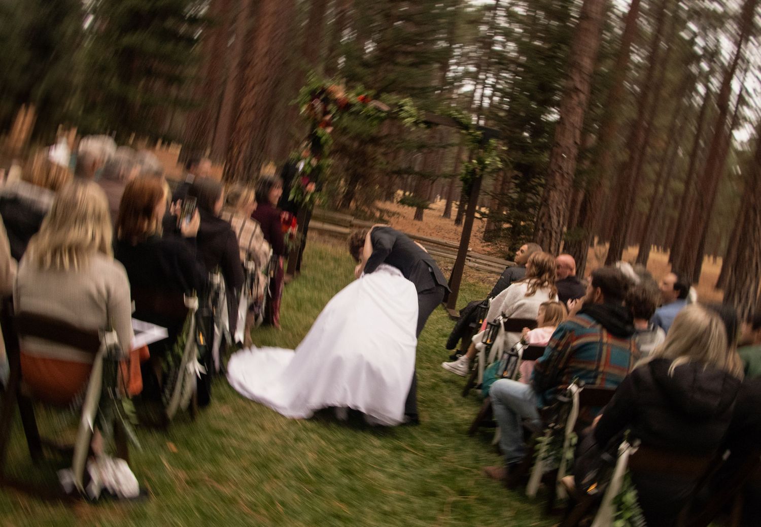 a groom dips his bride coming down the aisle after their Sisters, Oregon wedding ceremony