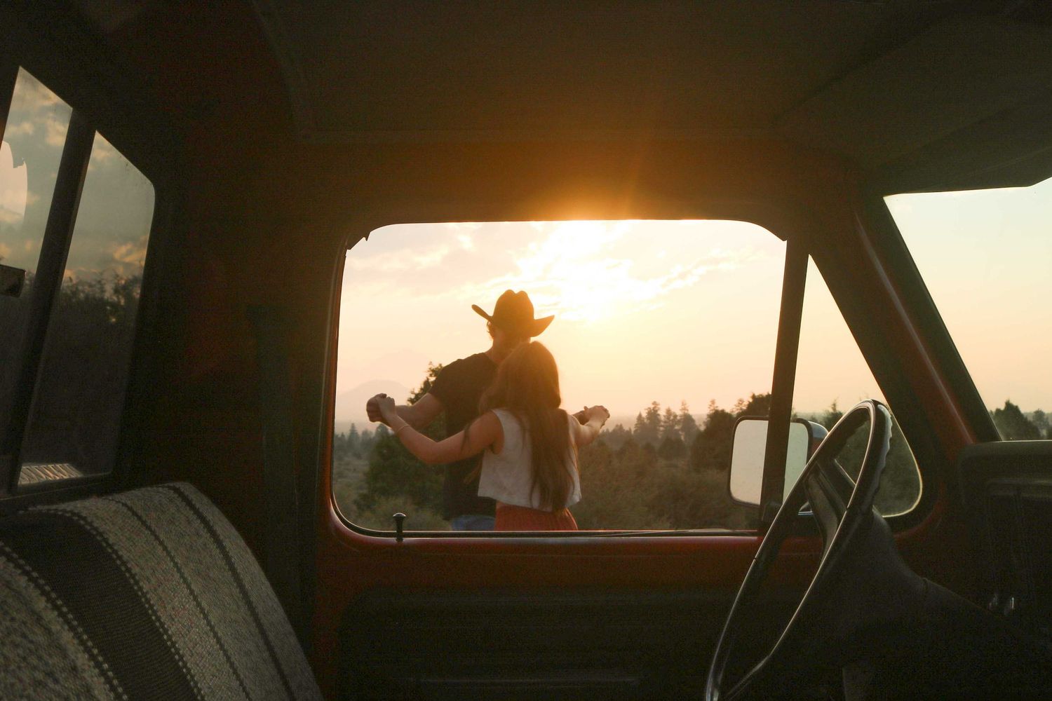a couple dances in the High Desert Sun next to their vintage truck
