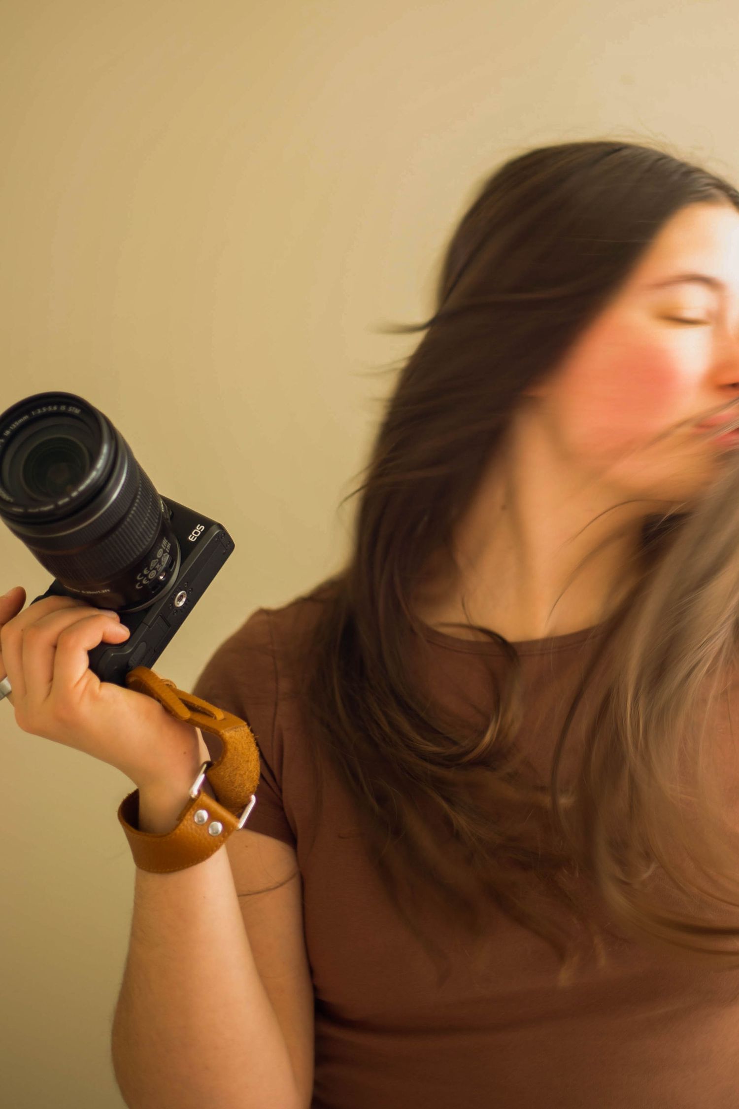 a photographer holds her camera at her studio in Bend, Oregon