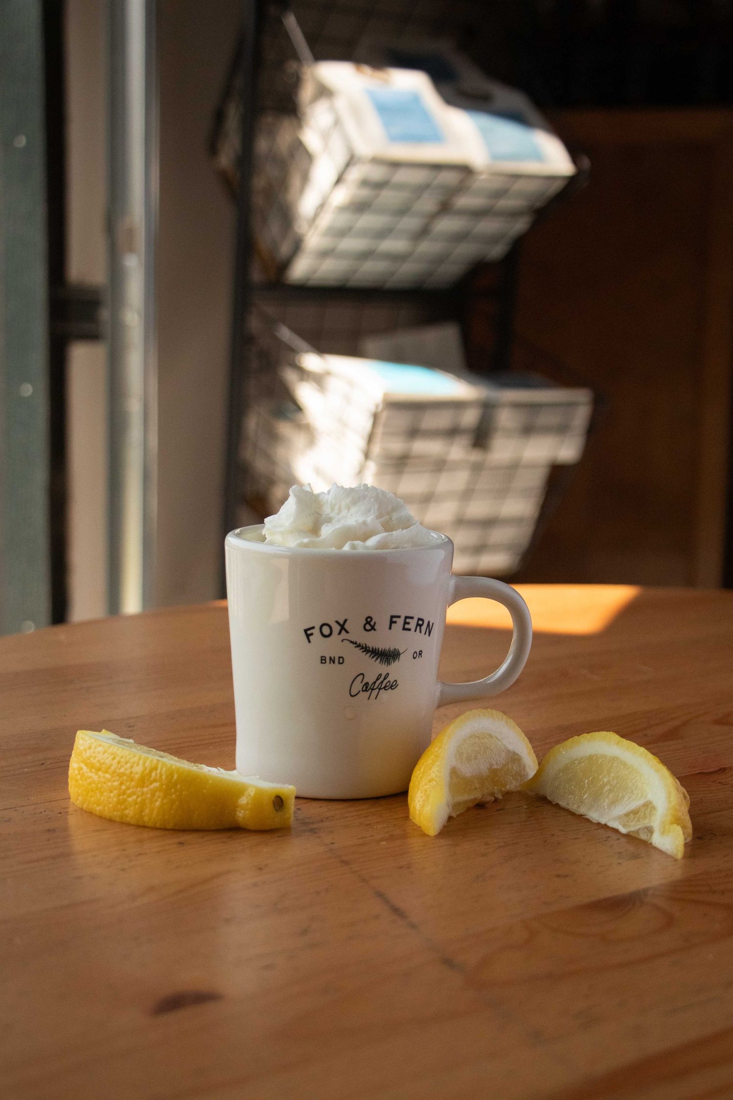 a cup of coffee rests on a sunny table in a Bend, Oregon coffee shop