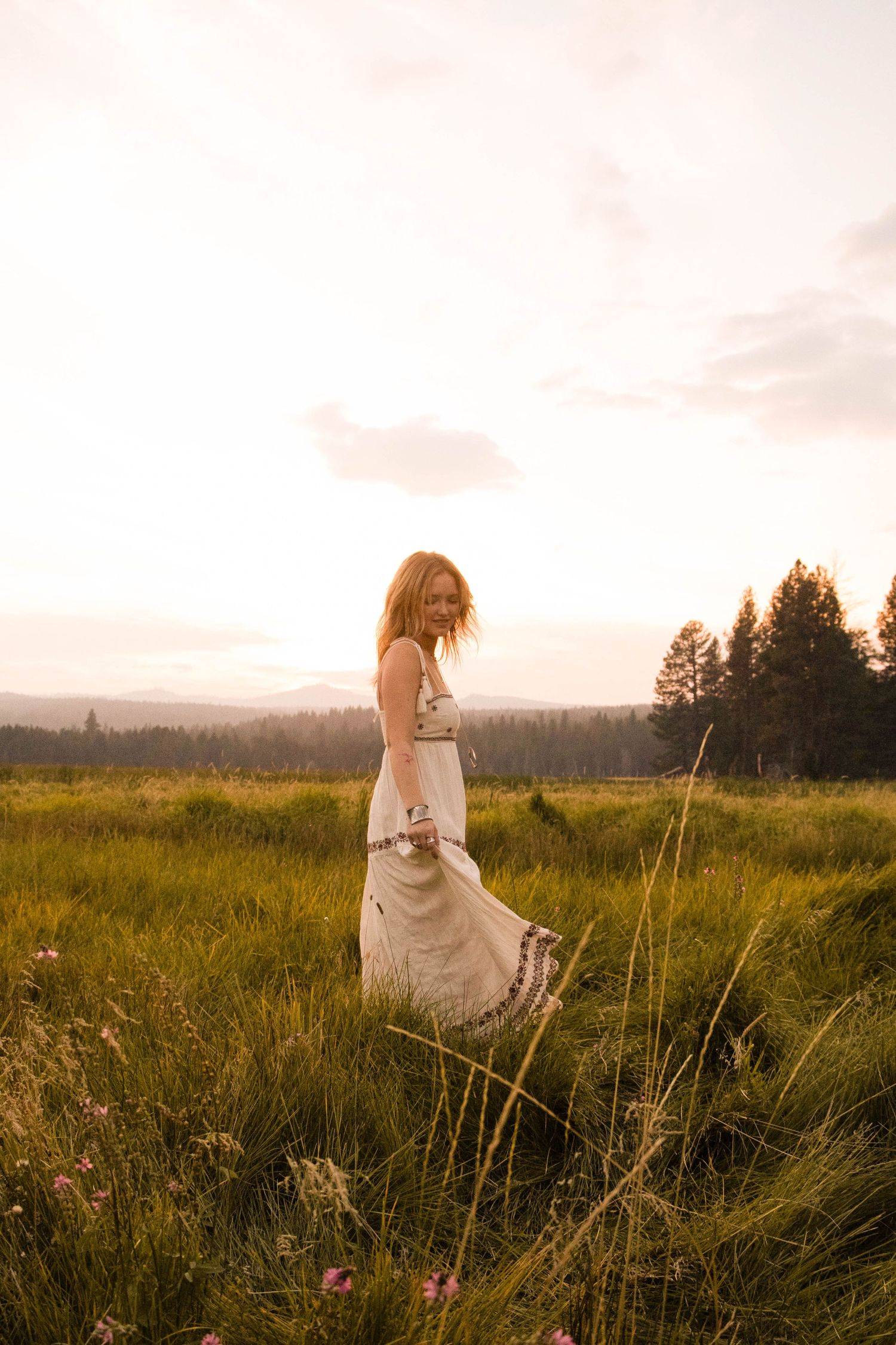 a high school senior from Bend, Oregon spins in a field at Dillon Falls