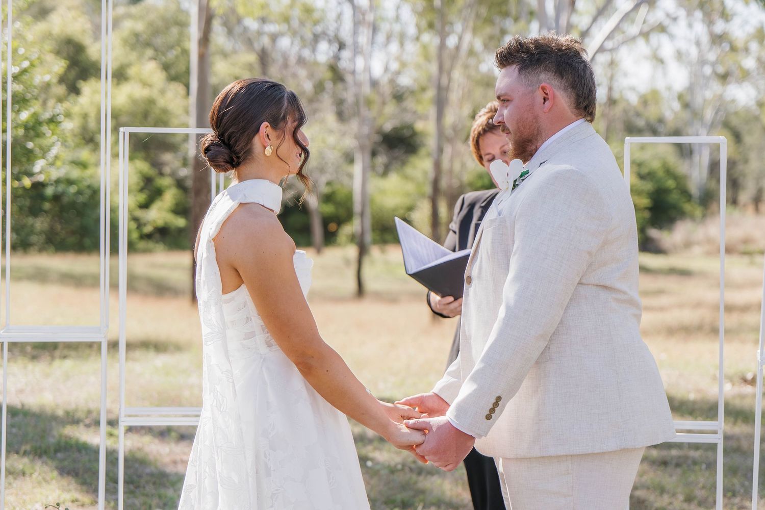 Couple sharing intimate first look moments in an outdoor setting.