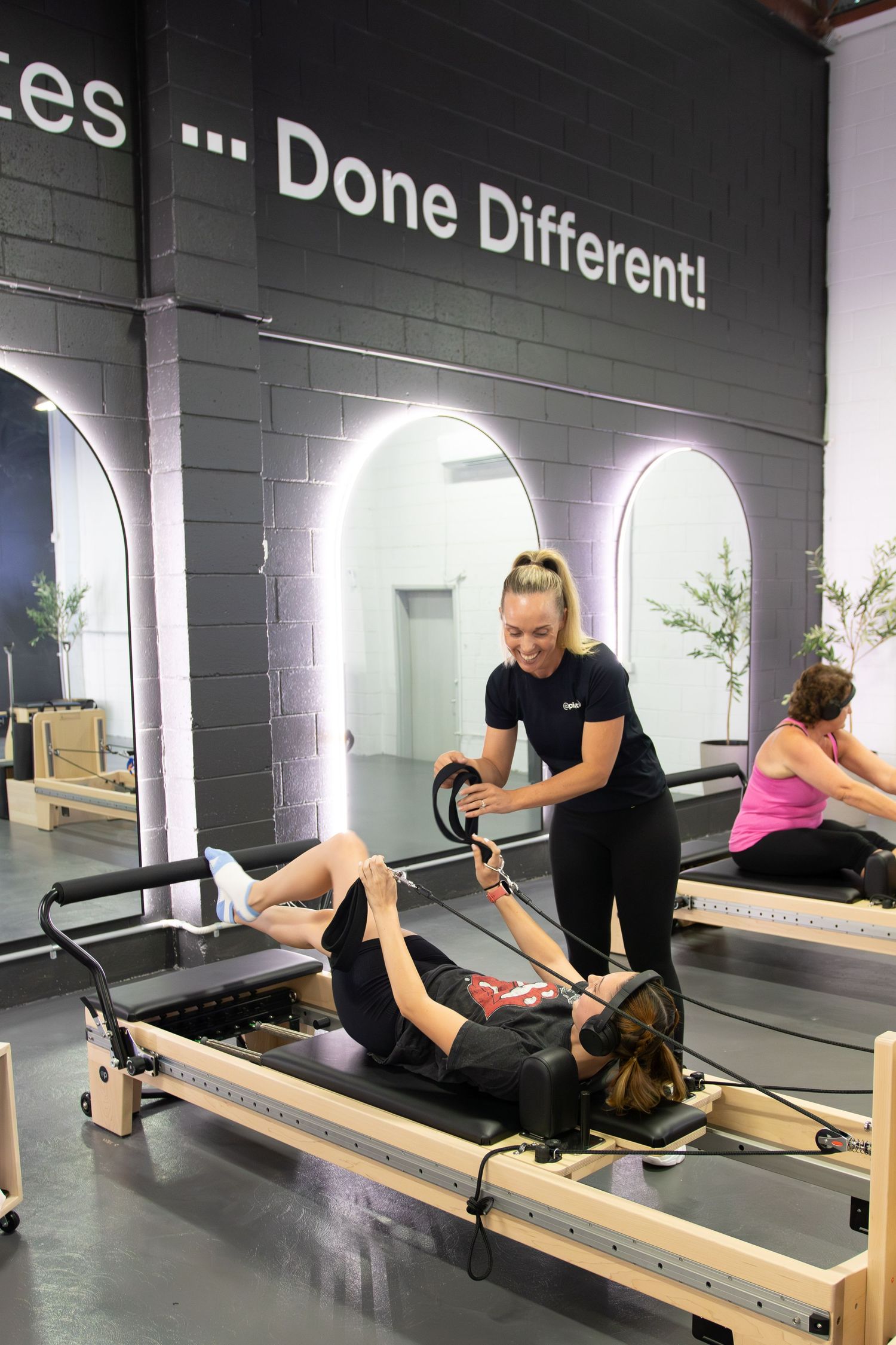 Pilates reformer workout session showing various exercises in a modern fitness studio.