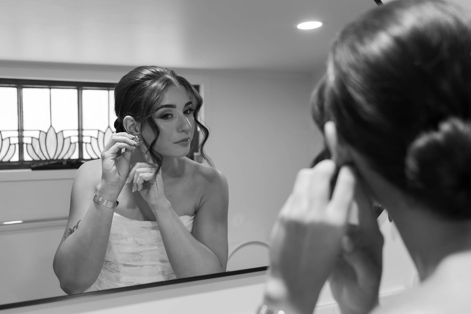 Getting ready moments captured in black and white during wedding preparations.