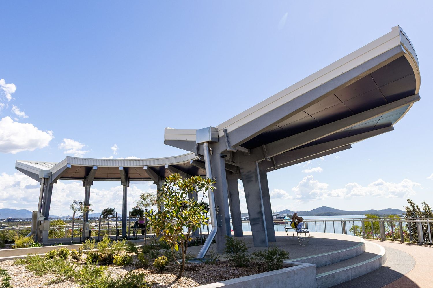 Architectural exterior shots showing modern building with angular roof design.