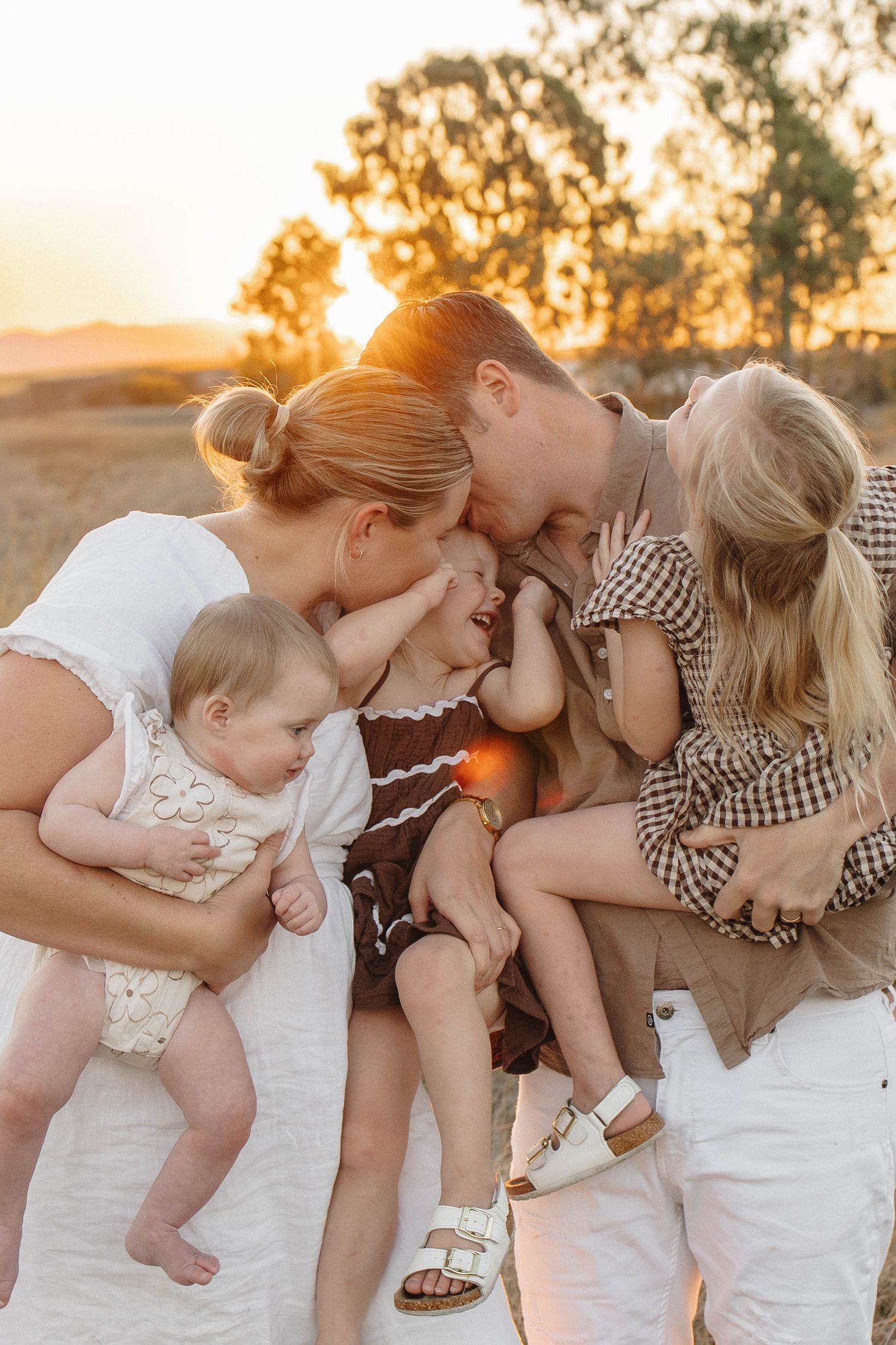 Sweet family interactions photographed during golden hour in a natural setting.