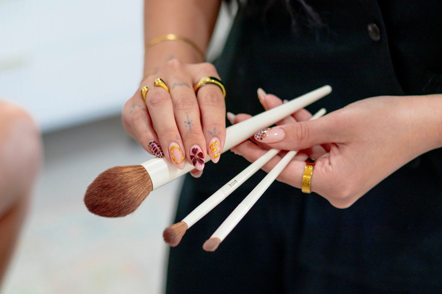 Close-up of hands holding white markers or pens during a meeting.