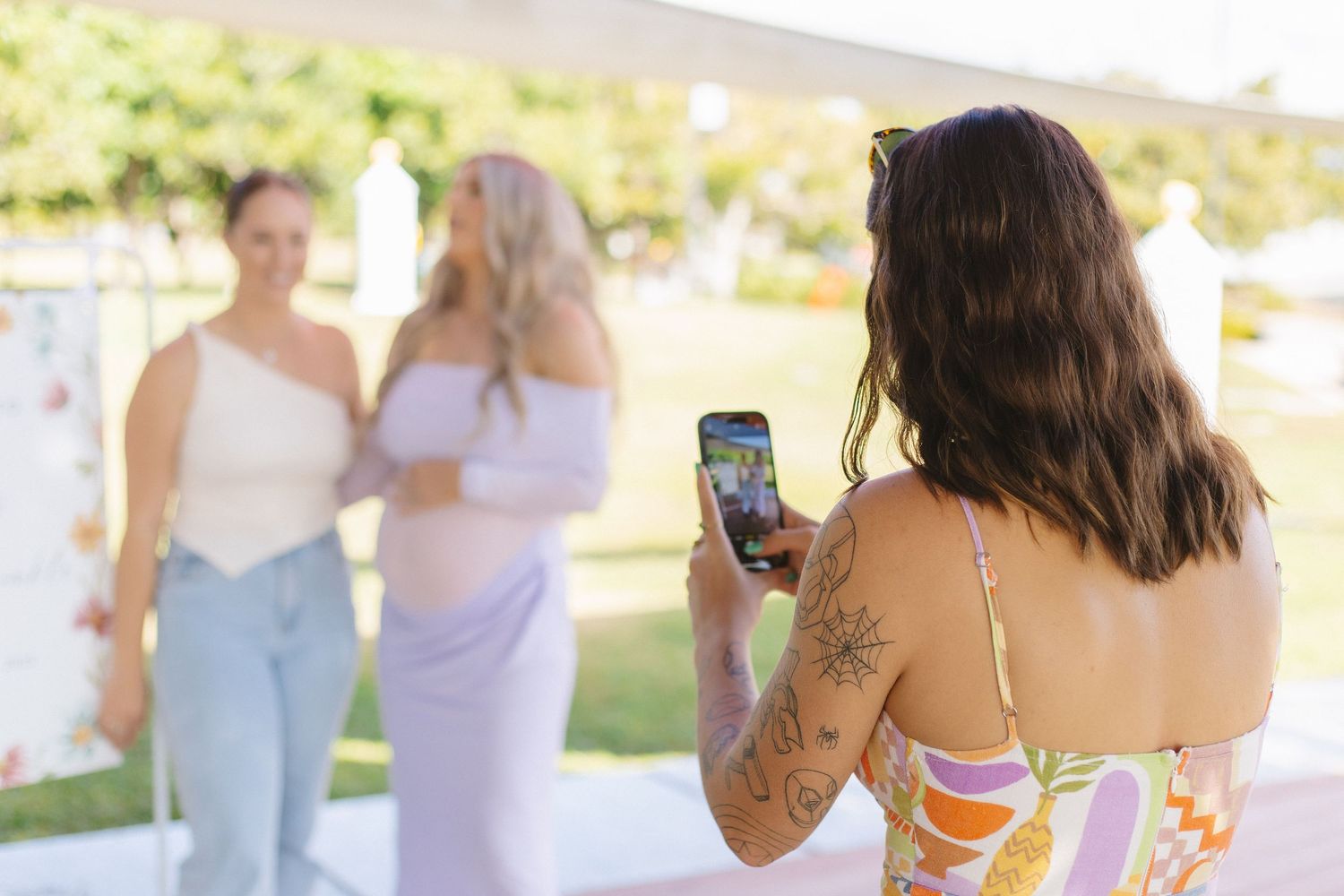 Group of friends enjoying outdoor gathering in casual summer attire.